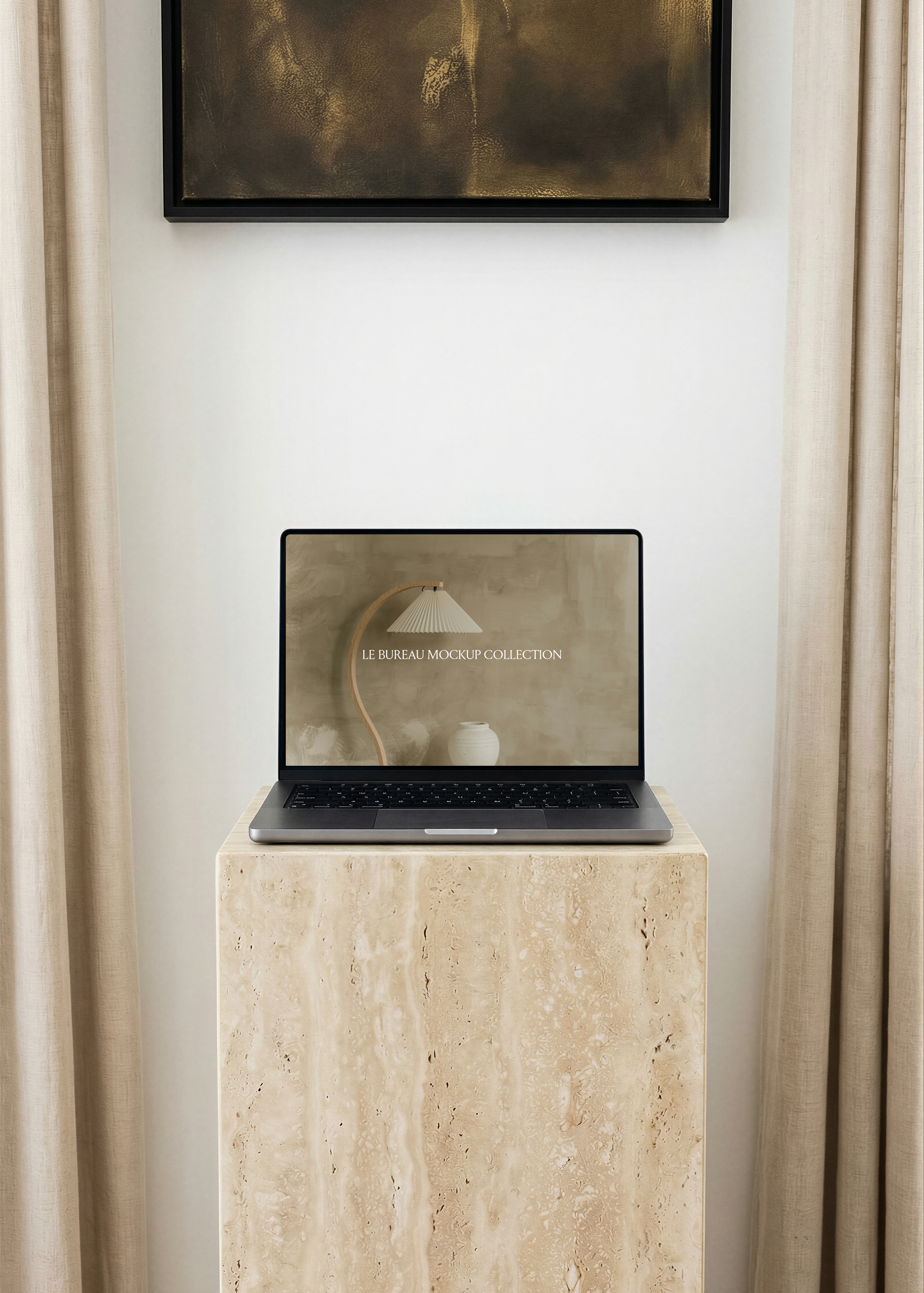 MacBook mockup displaying Le Bureau editorial on travertine plinth, linen curtain and dark gold artwork frame backdrop