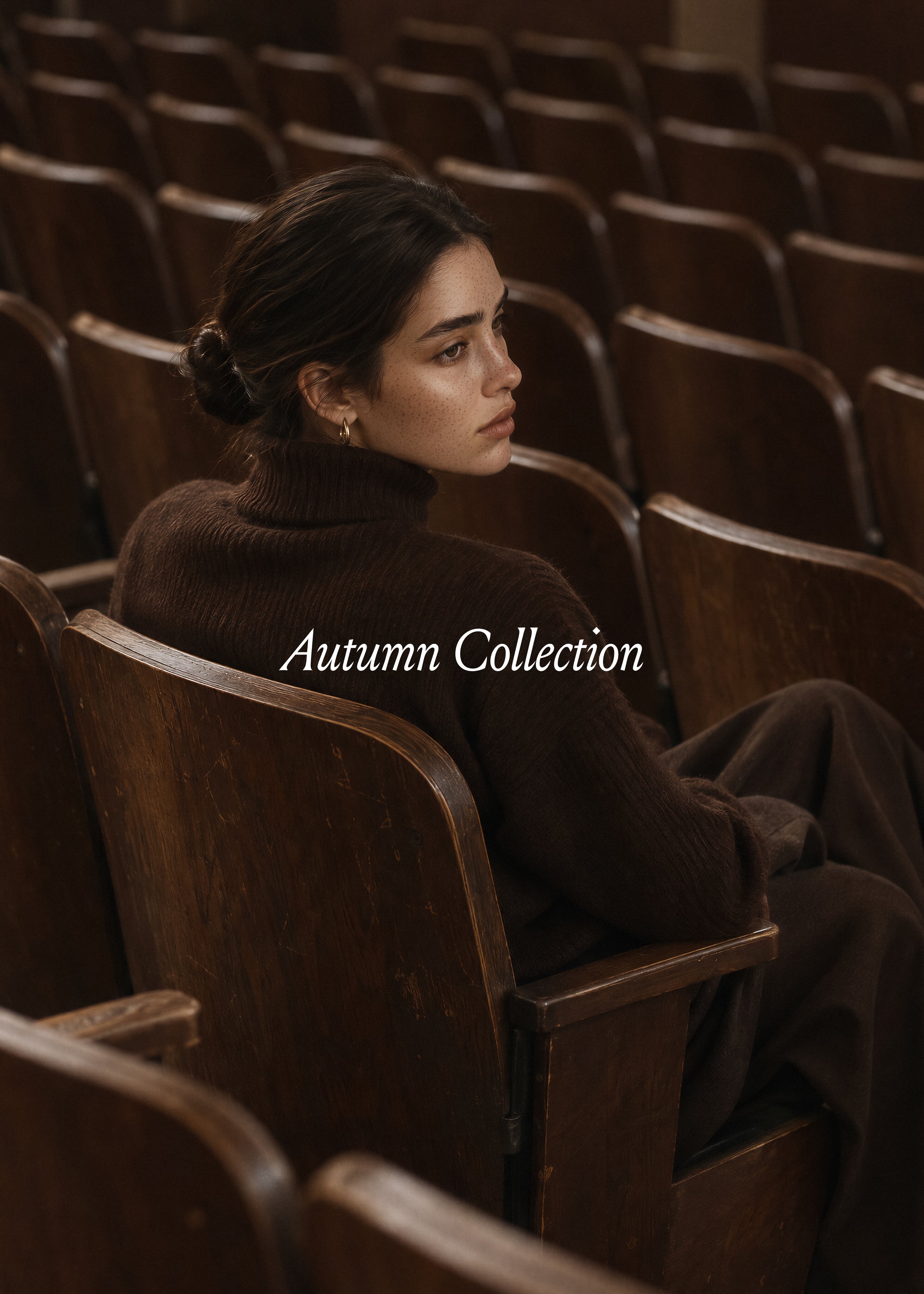 Woman in a brown roll neck seen from behind in vintage wooden theatre seats, Autumn Collection cover, Studio Blanche