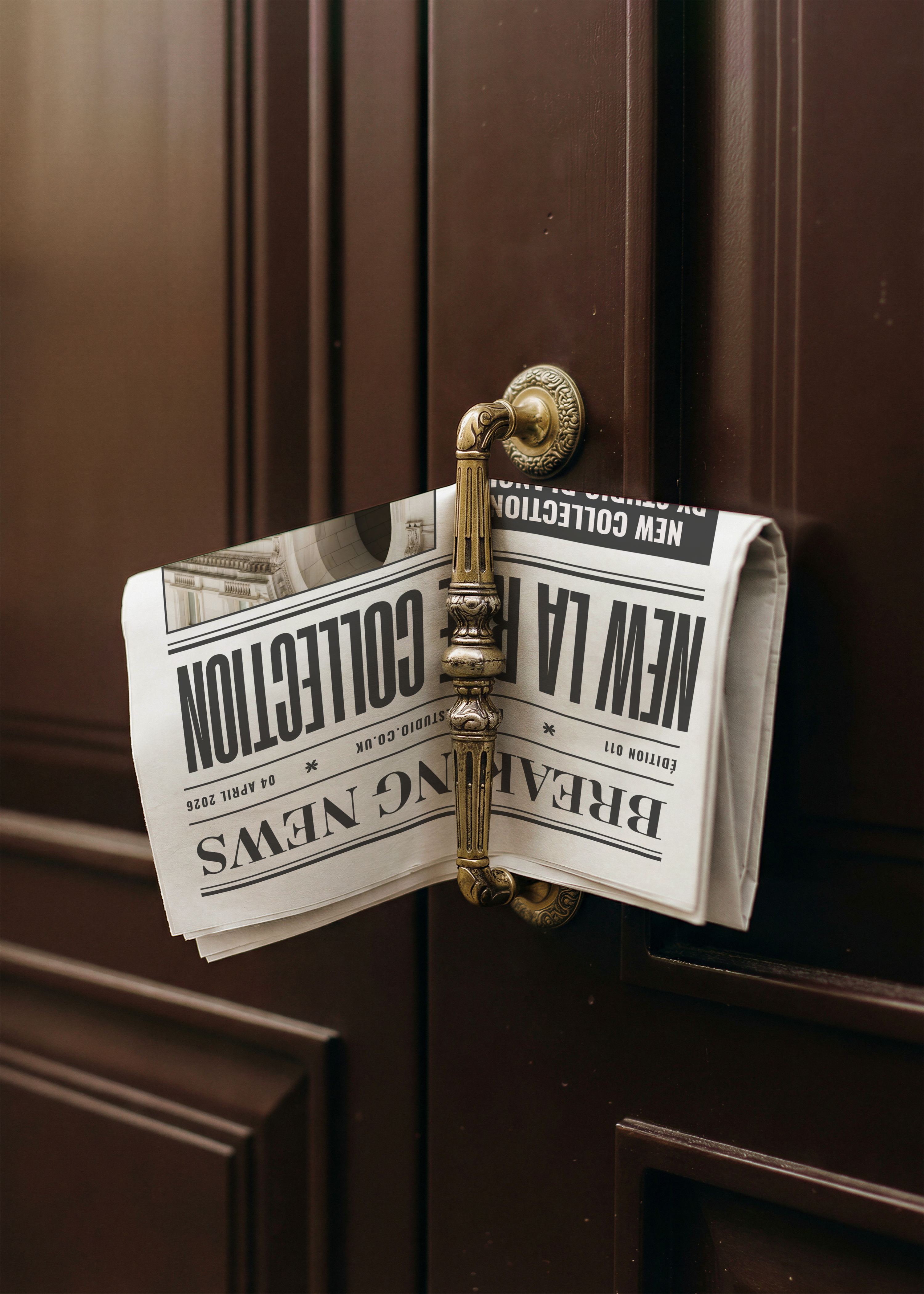 Newspaper mockup with bold headline typography folded over a vintage brass handle against a dark brown door
