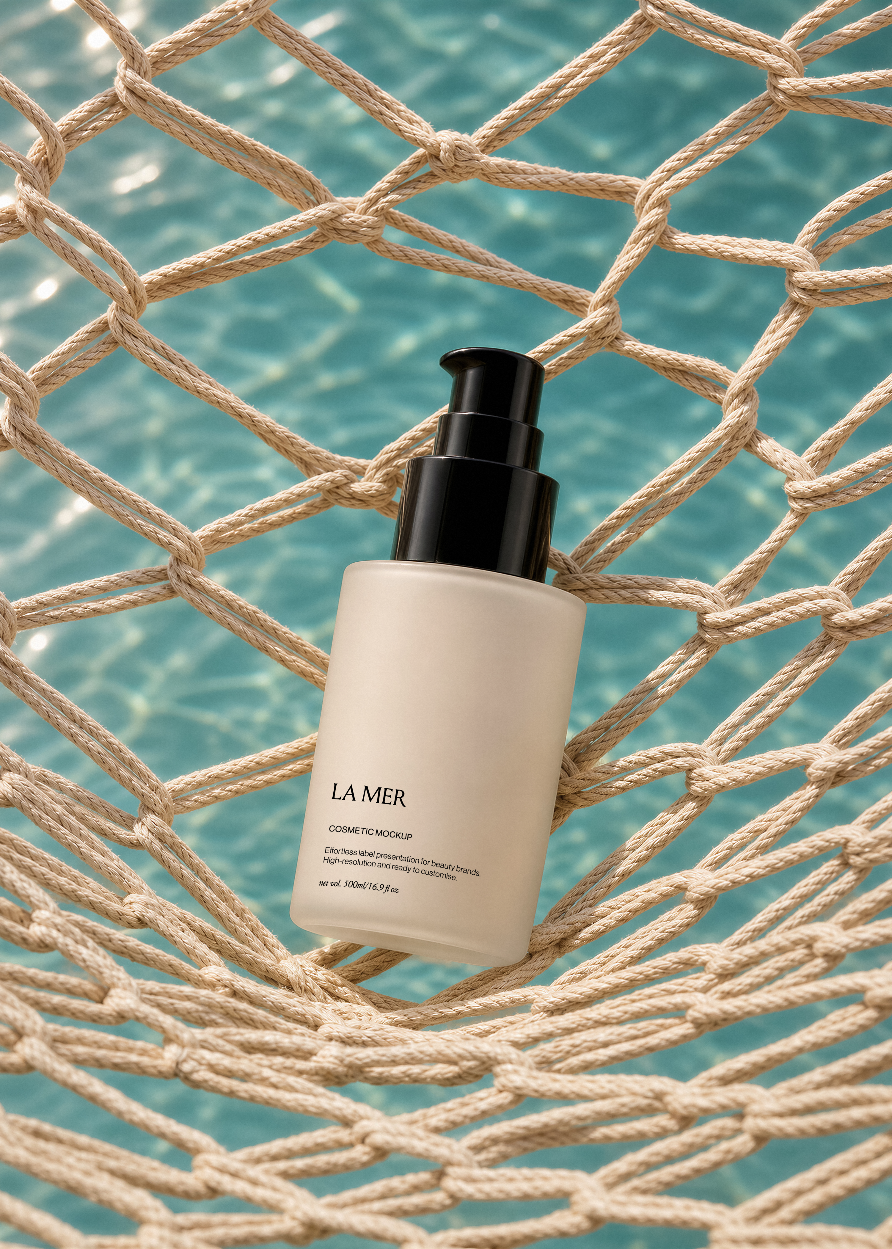 Frosted glass pump bottle mockup with black pump resting on a beige rope net over a turquoise pool, coastal styling