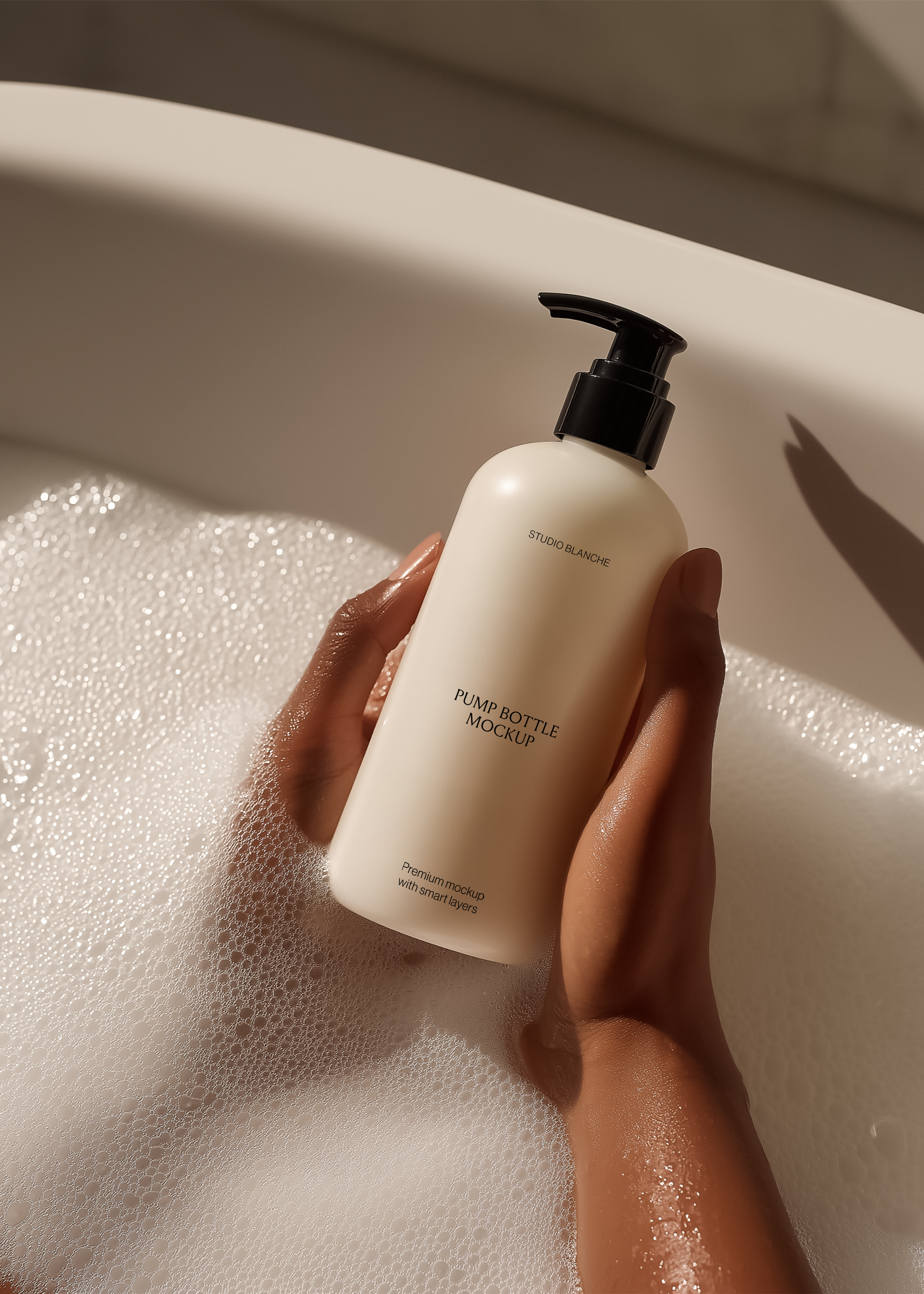 Off-white pump bottle mockup held over white bath foam, soft shadows and warm tones, minimal editorial styling