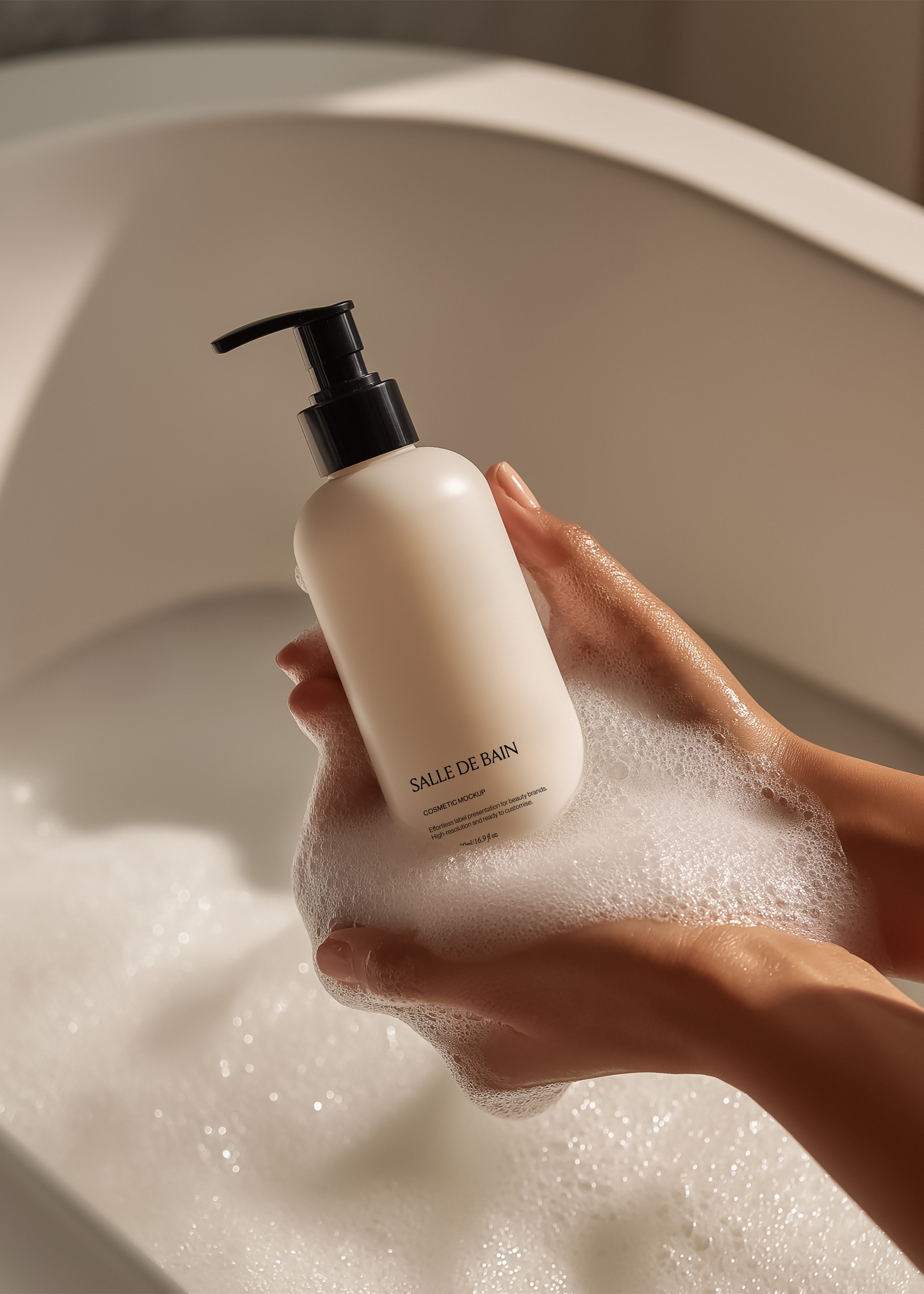 Off-white pump bottle mockup resting on soft suds in cupped hands, warm directional light, minimal editorial mood