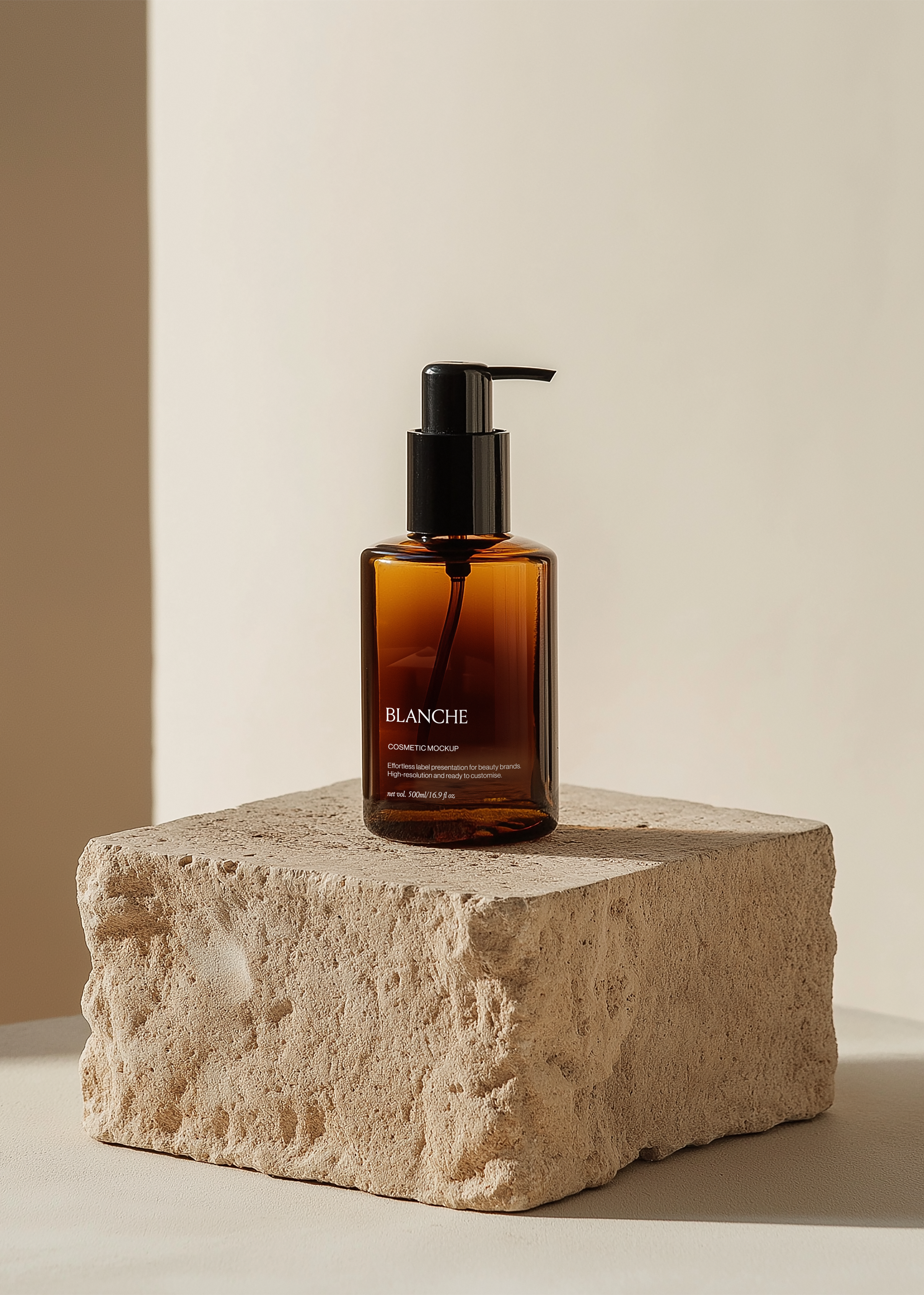 Amber cosmetic pump bottle mockup with black dispenser on rough limestone block in warm sunlight, editorial scene