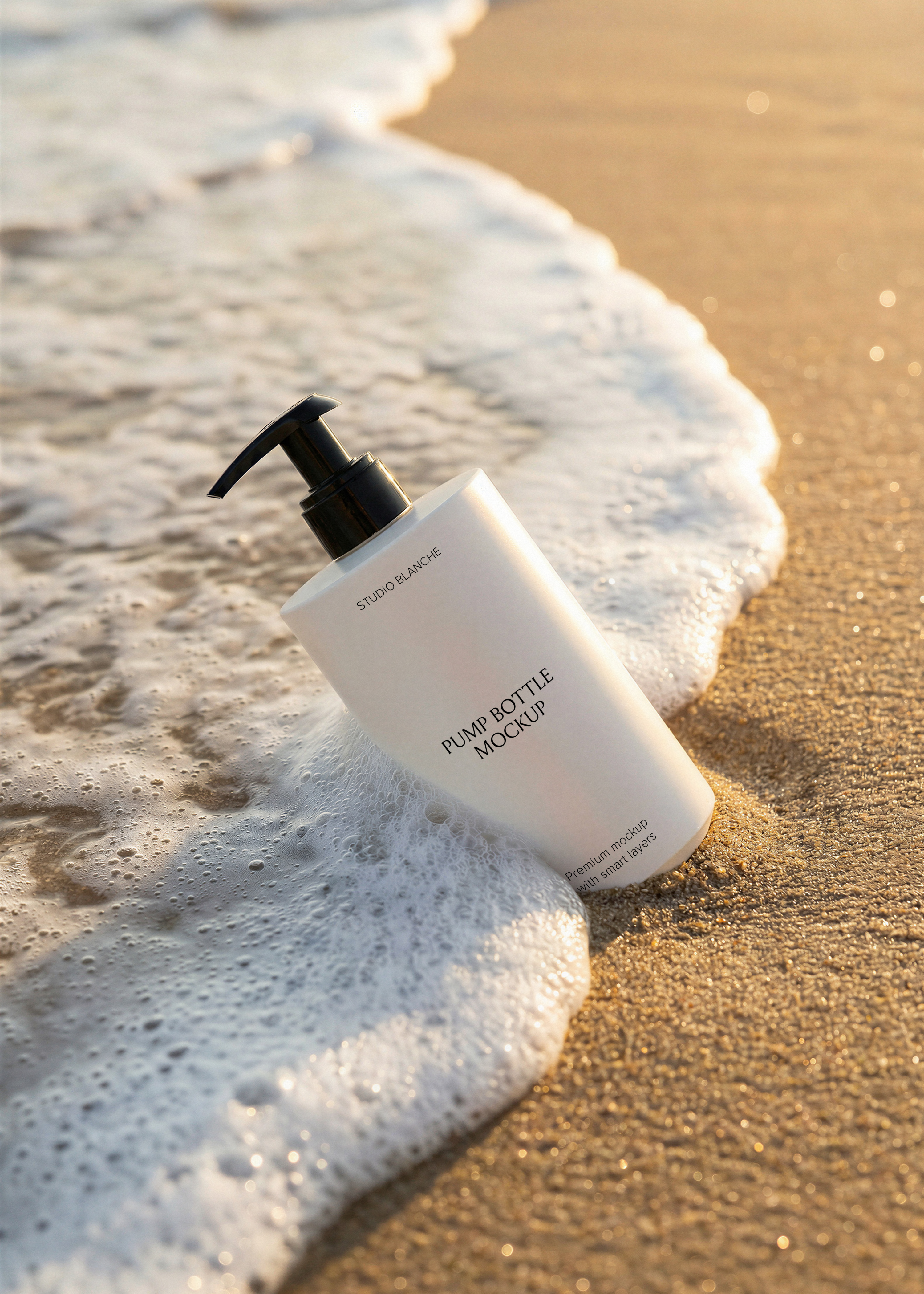 Blank white pump bottle with black dispenser leaning in golden sand with a foamy wave at sunset on a sparkling beach, from Studio Blanche