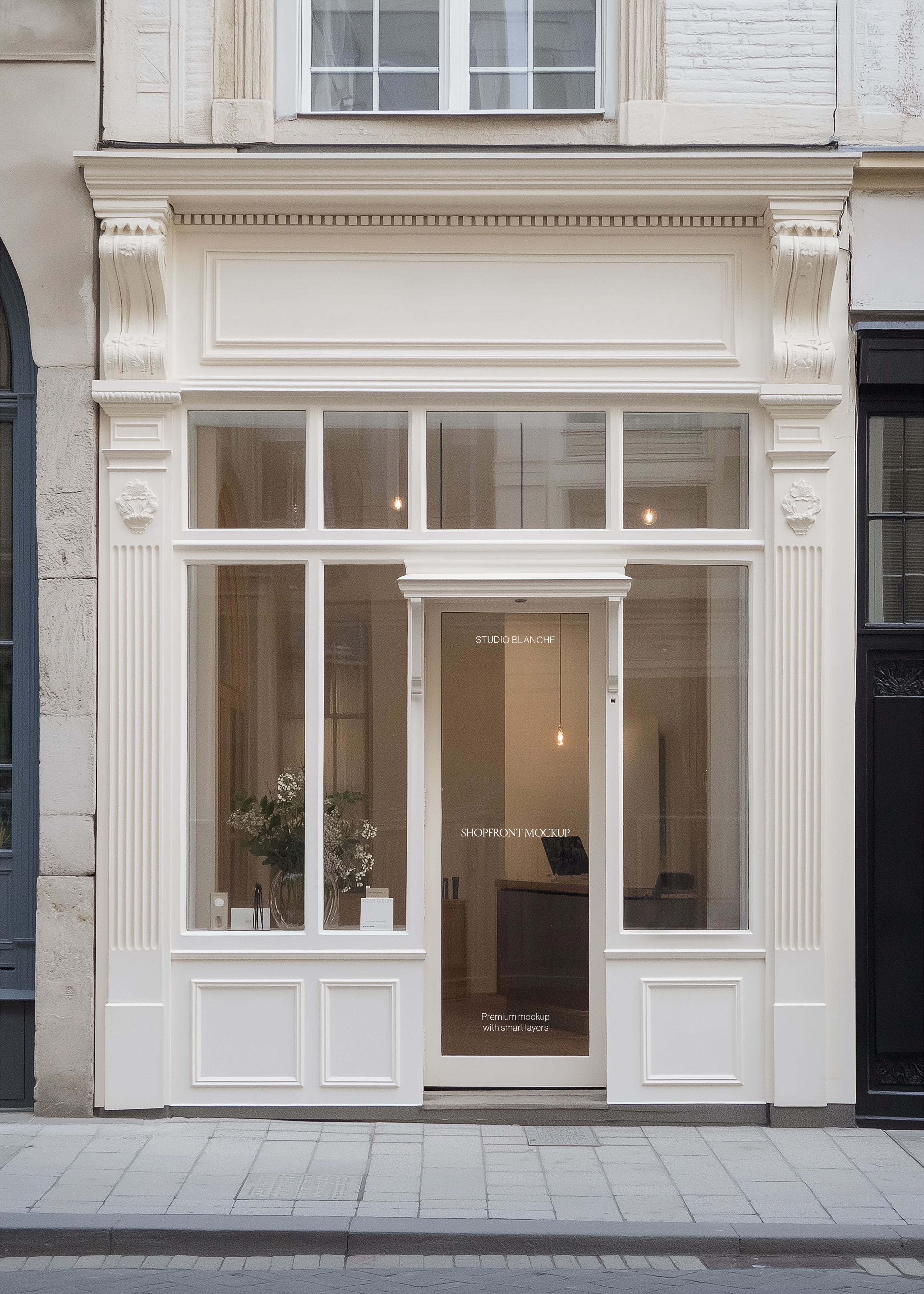 Retail storefront mockup with cream moulded facade, fluted pilasters, floral window display and grey paved pavement