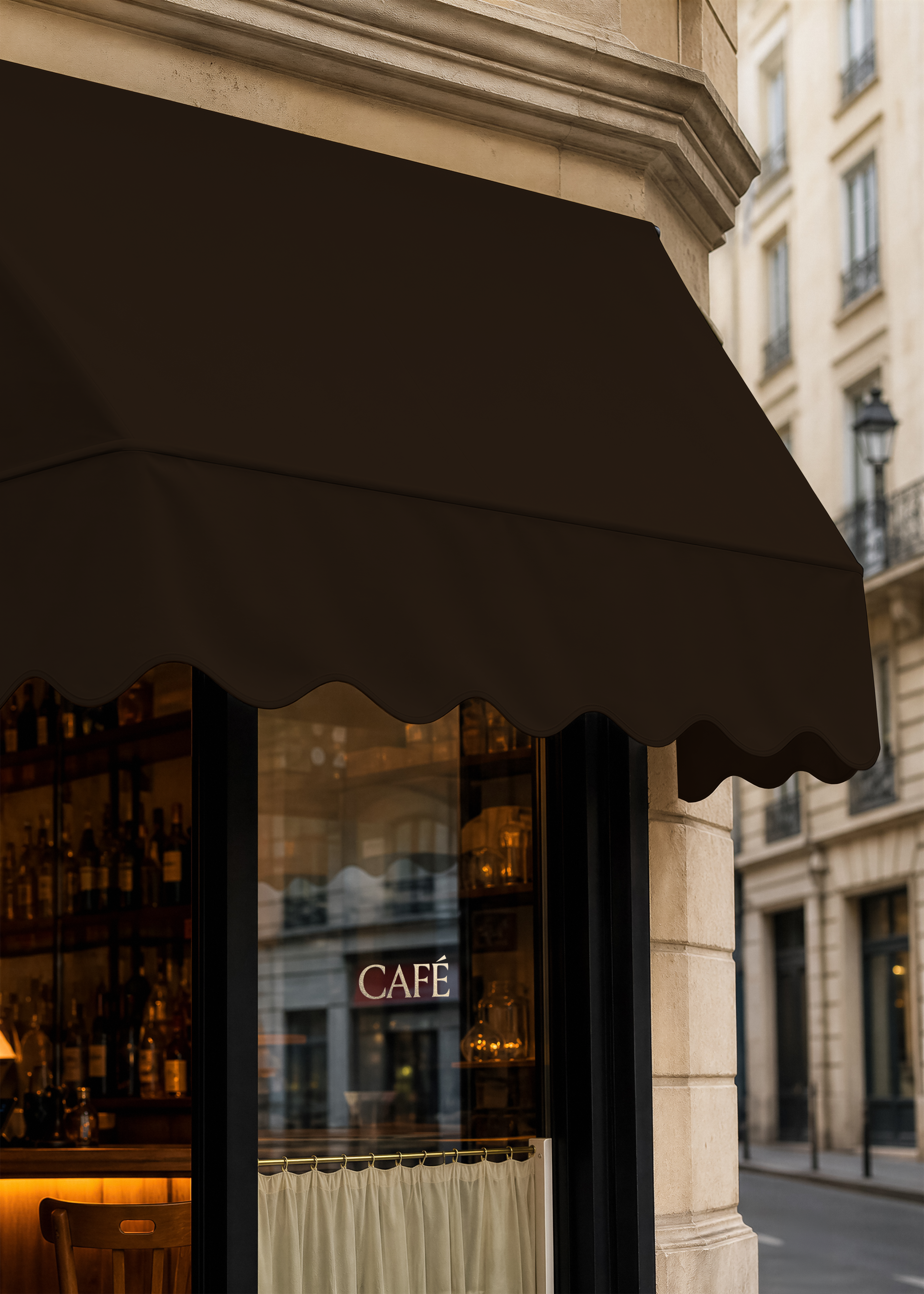 Café canopy mockup, dark brown scalloped awning above shopfront window with CAFÉ lettering, stone corner building