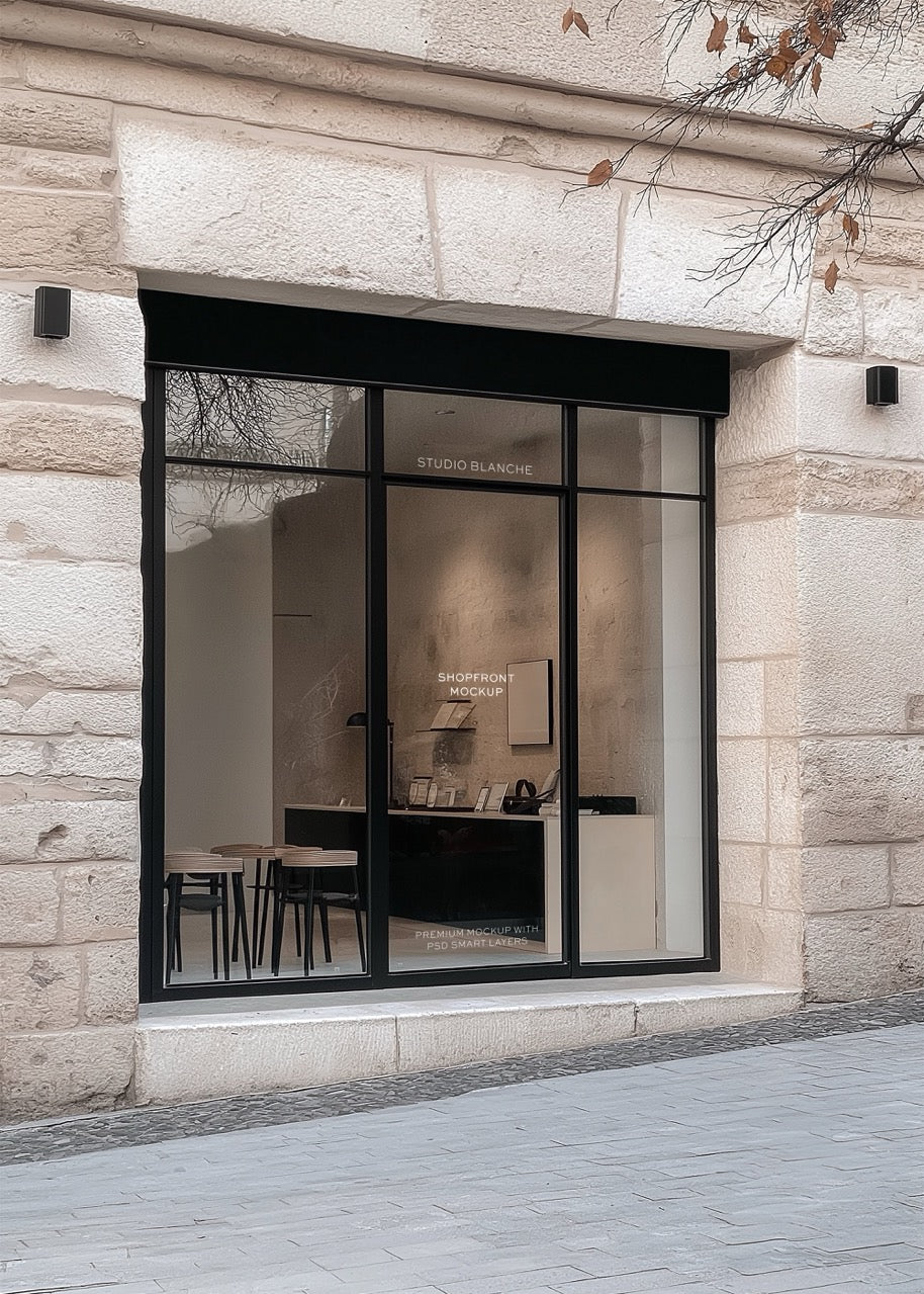 Storefront mockup with large glass window on a stone building