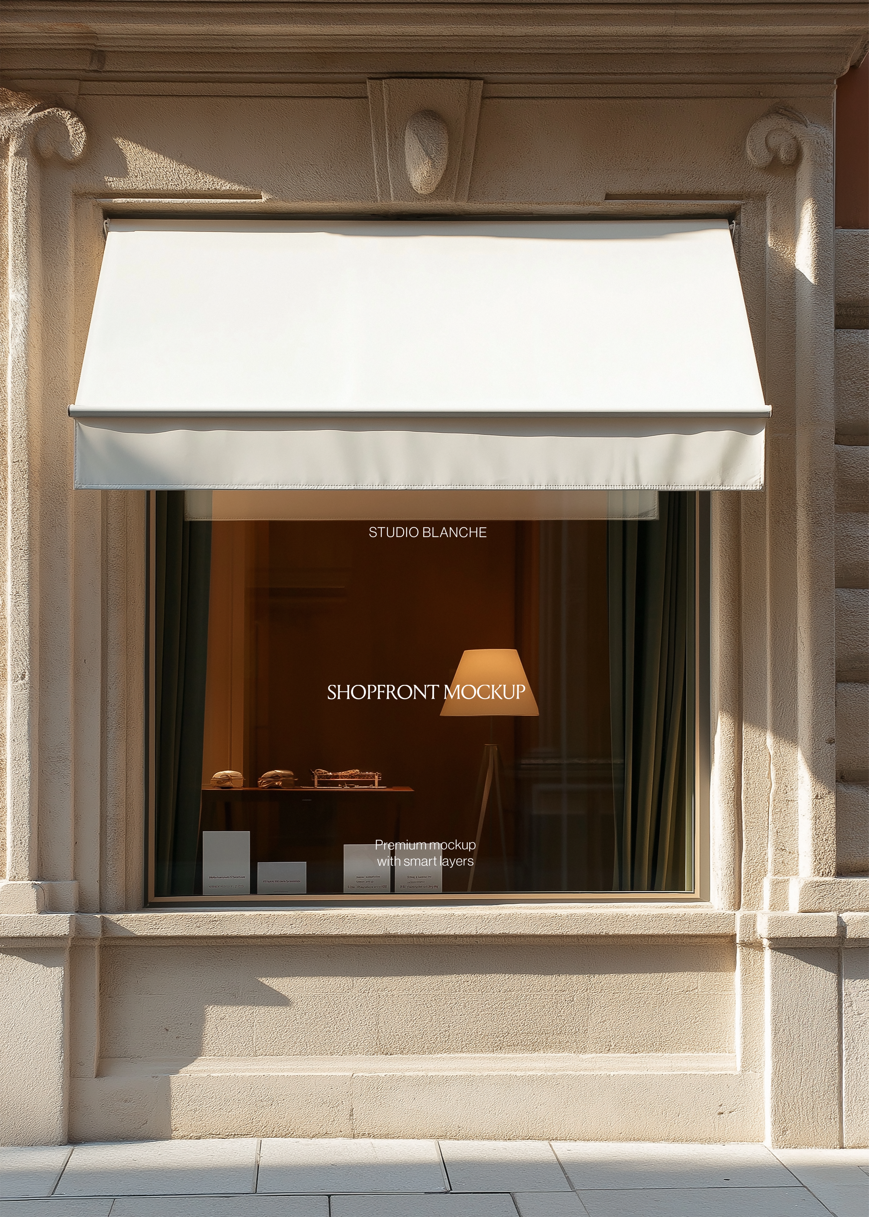 Awning storefront mockup with sunlit stone facade, glowing table lamp, product display table and pale paving