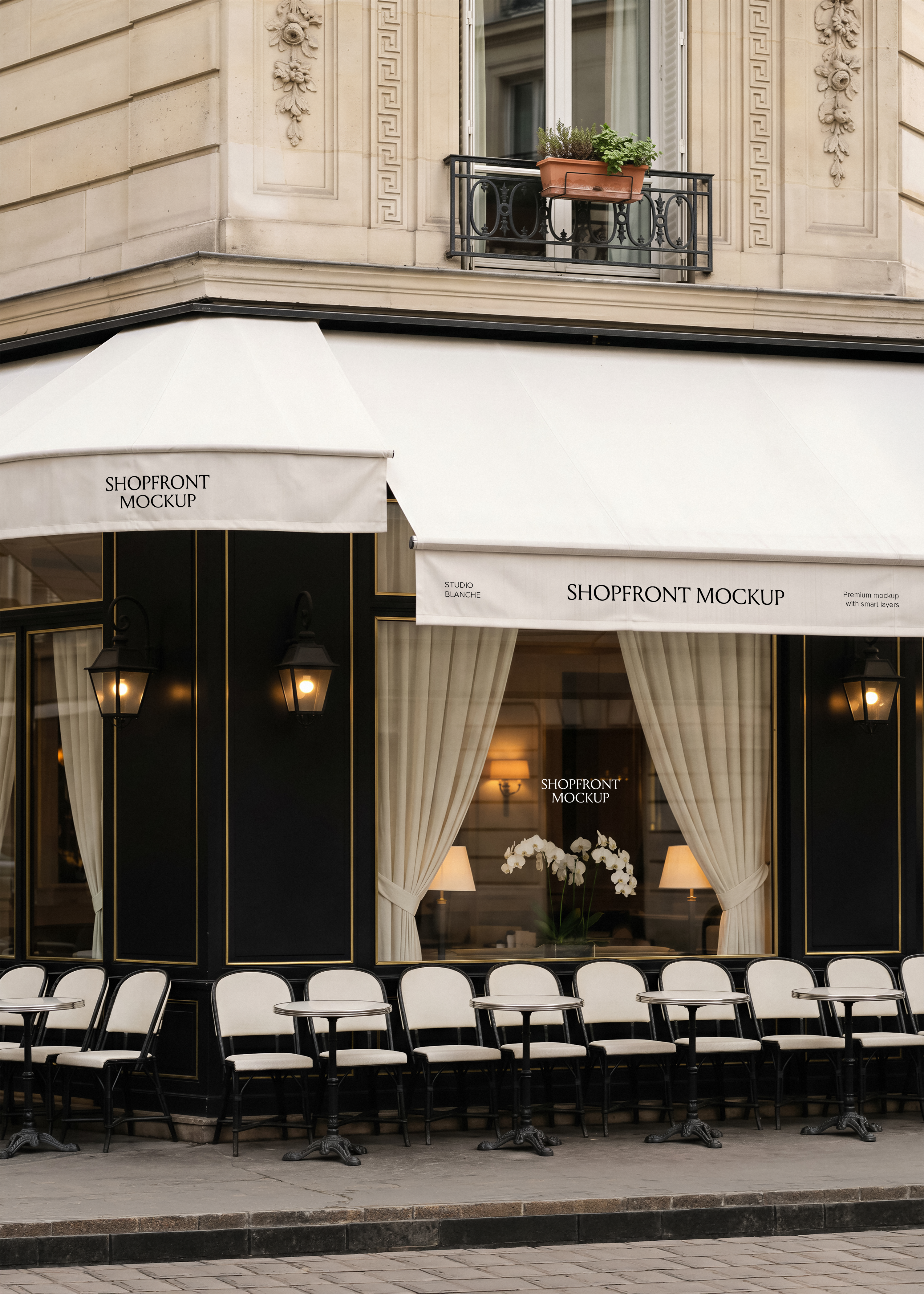 Café shopfront mockup with cream awning, black and gold facade panelling, bistro seating, wrought iron lanterns, Haussmann building backdrop