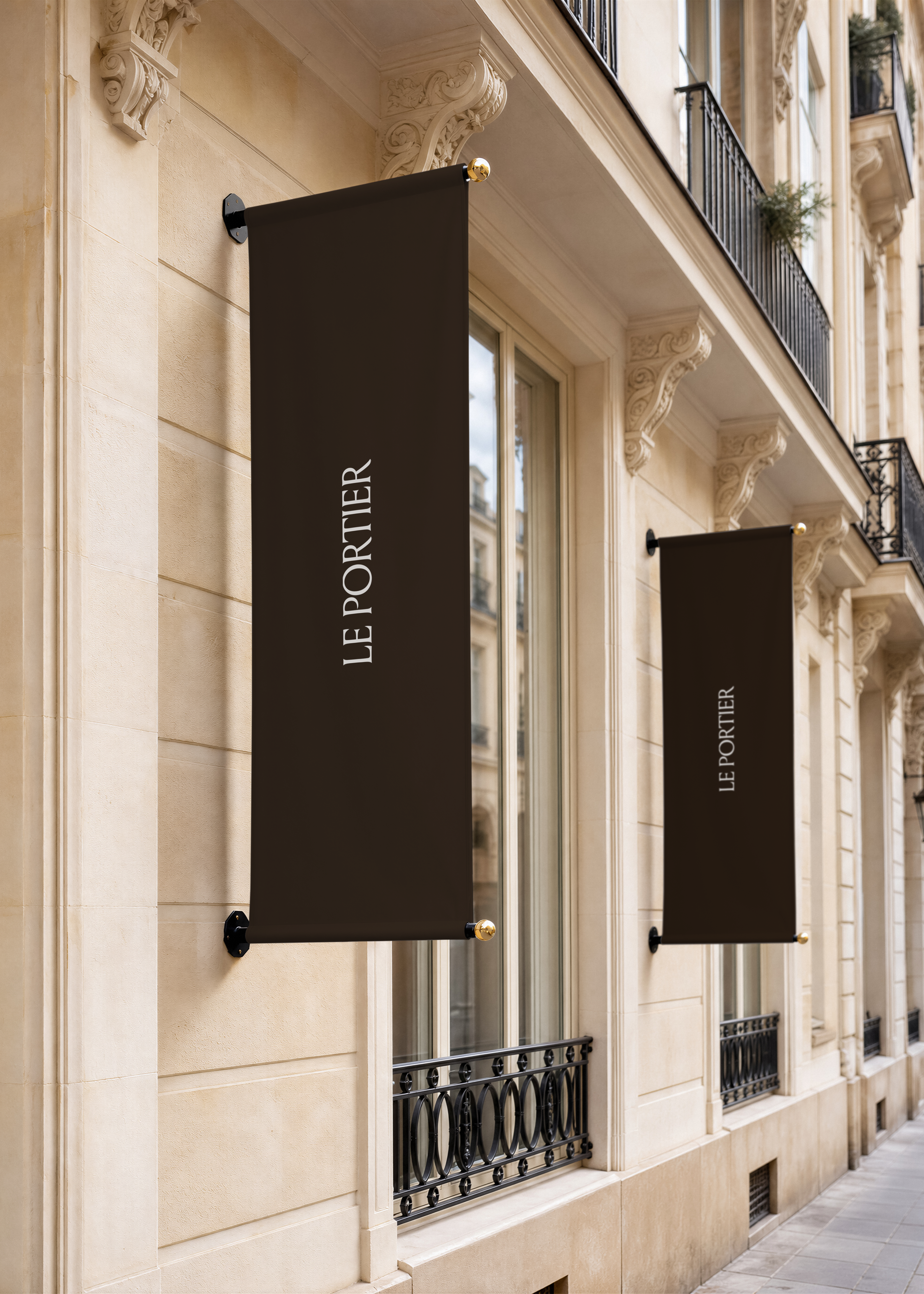Two hanging fabric banner sign mockups mounted on a pale stone Parisian facade above iron balconies