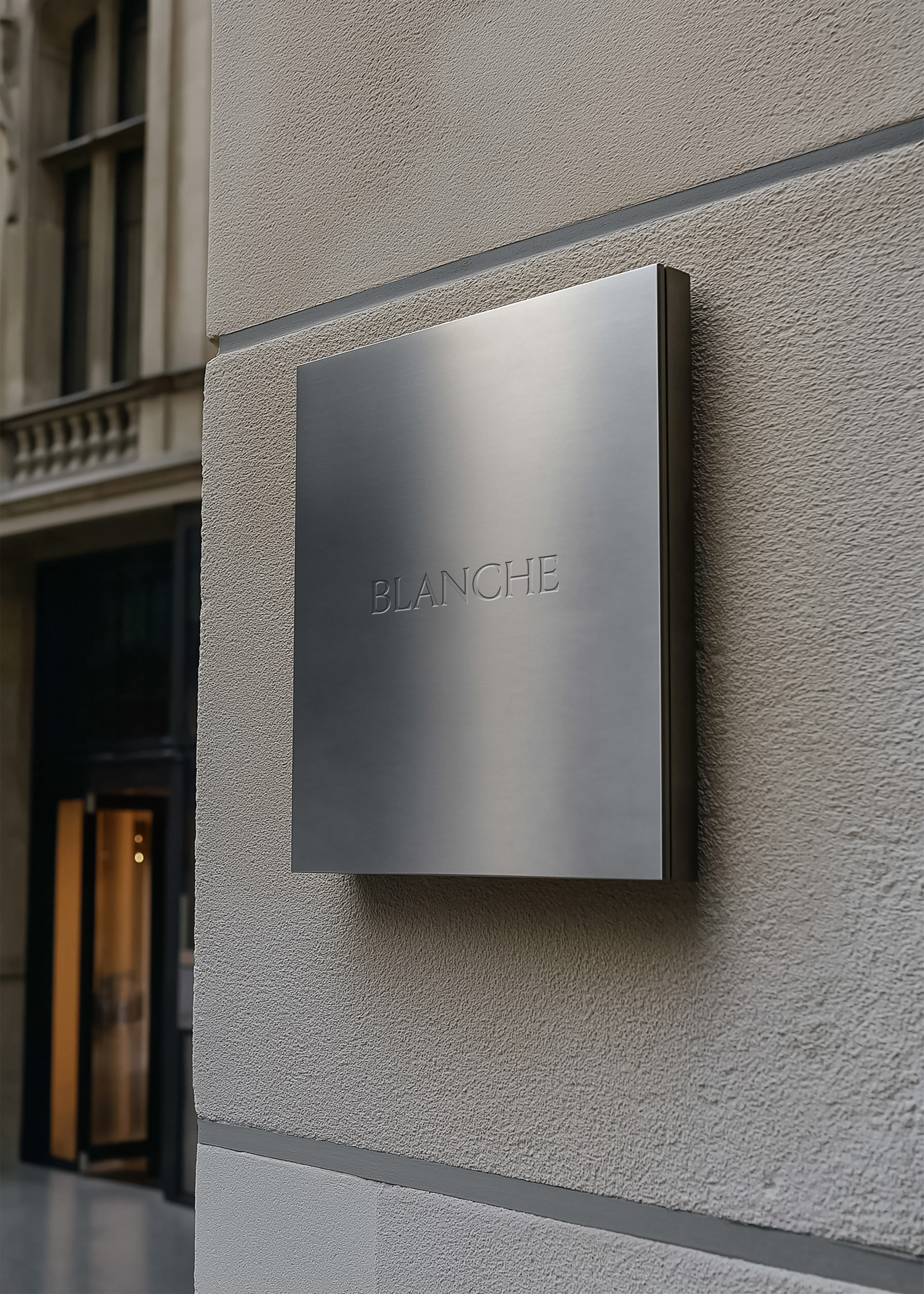 Metal sign mockup with engraved serif brand name on brushed steel panel, grey render facade, architectural street scene