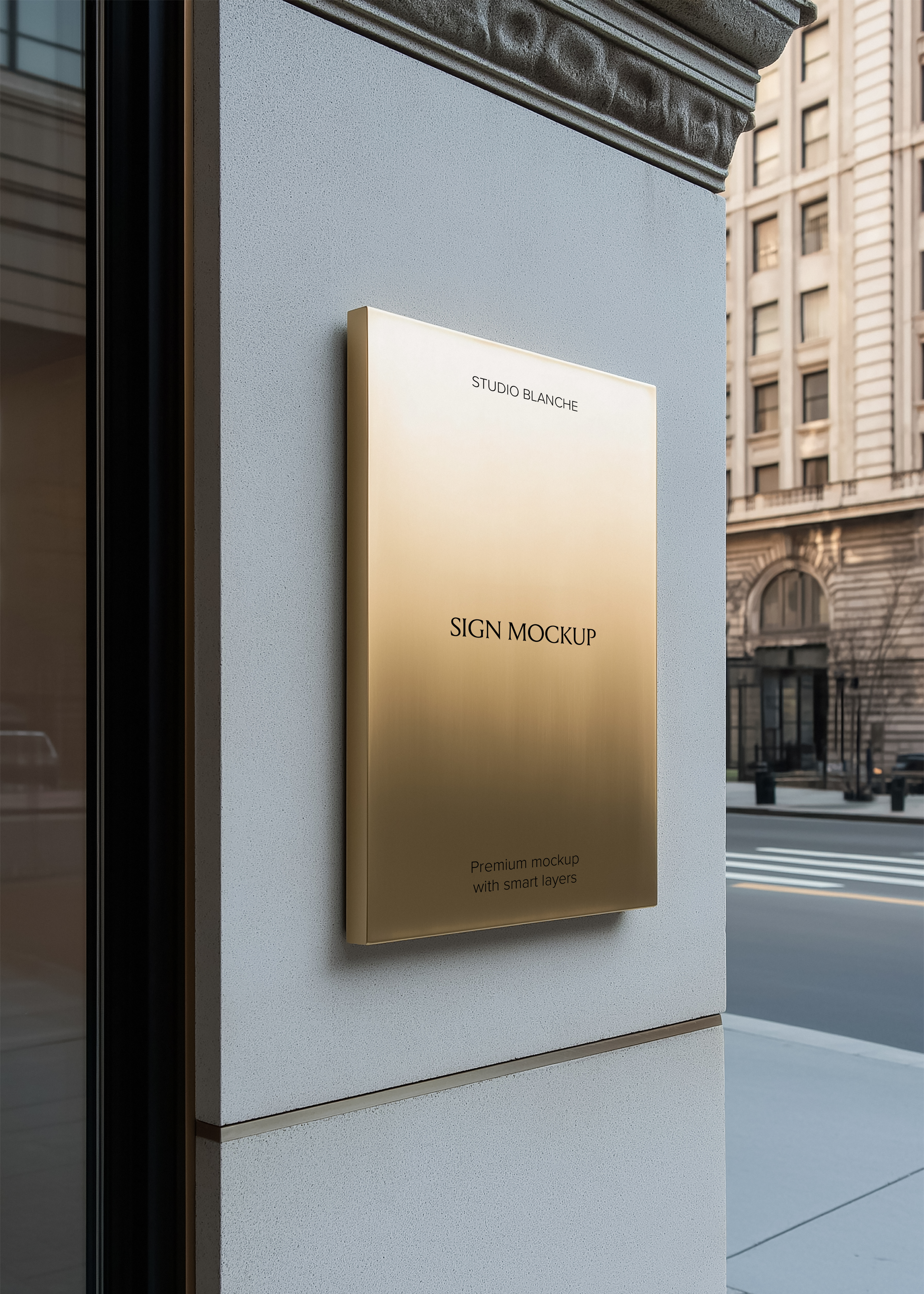 Brushed gold rectangular sign mockup mounted on pale stone pillar, city street and classical building facade in background