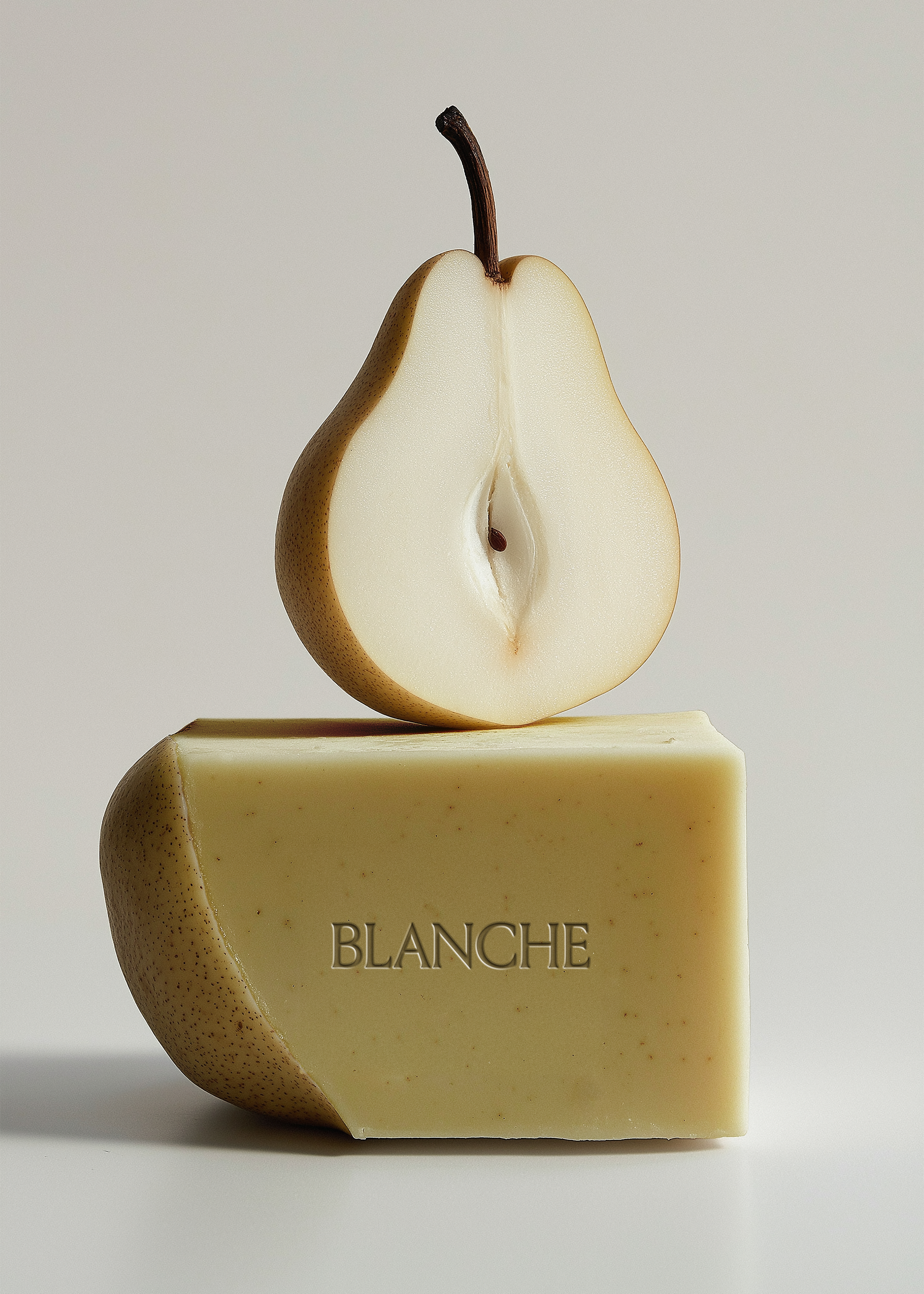 Large olive-toned textured soap bar with halved pear balanced on top, grey background, embossed brand label