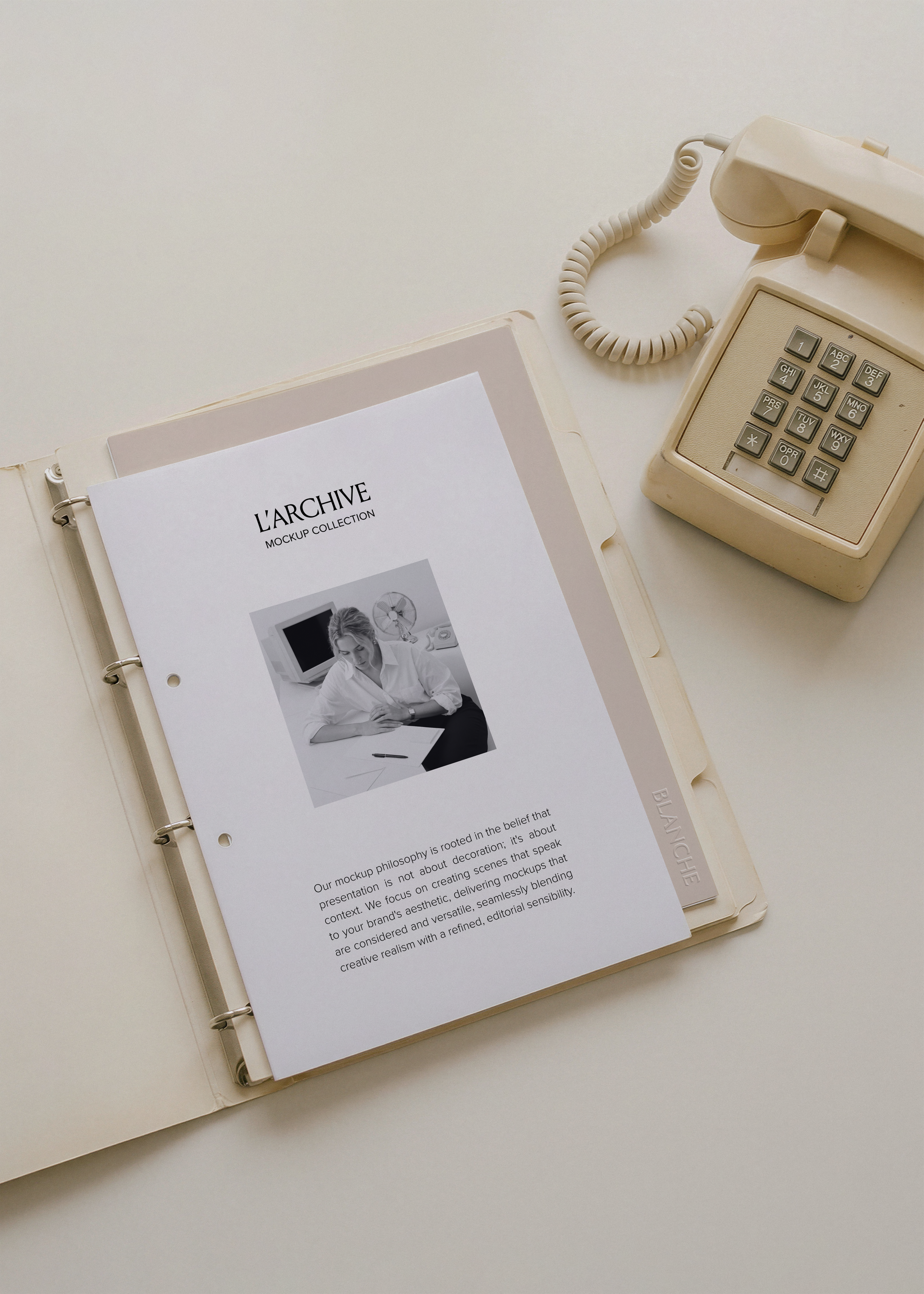 A4 card stationery mockup filed in cream three-ring binder with tabbed dividers beside vintage push-button desk phone