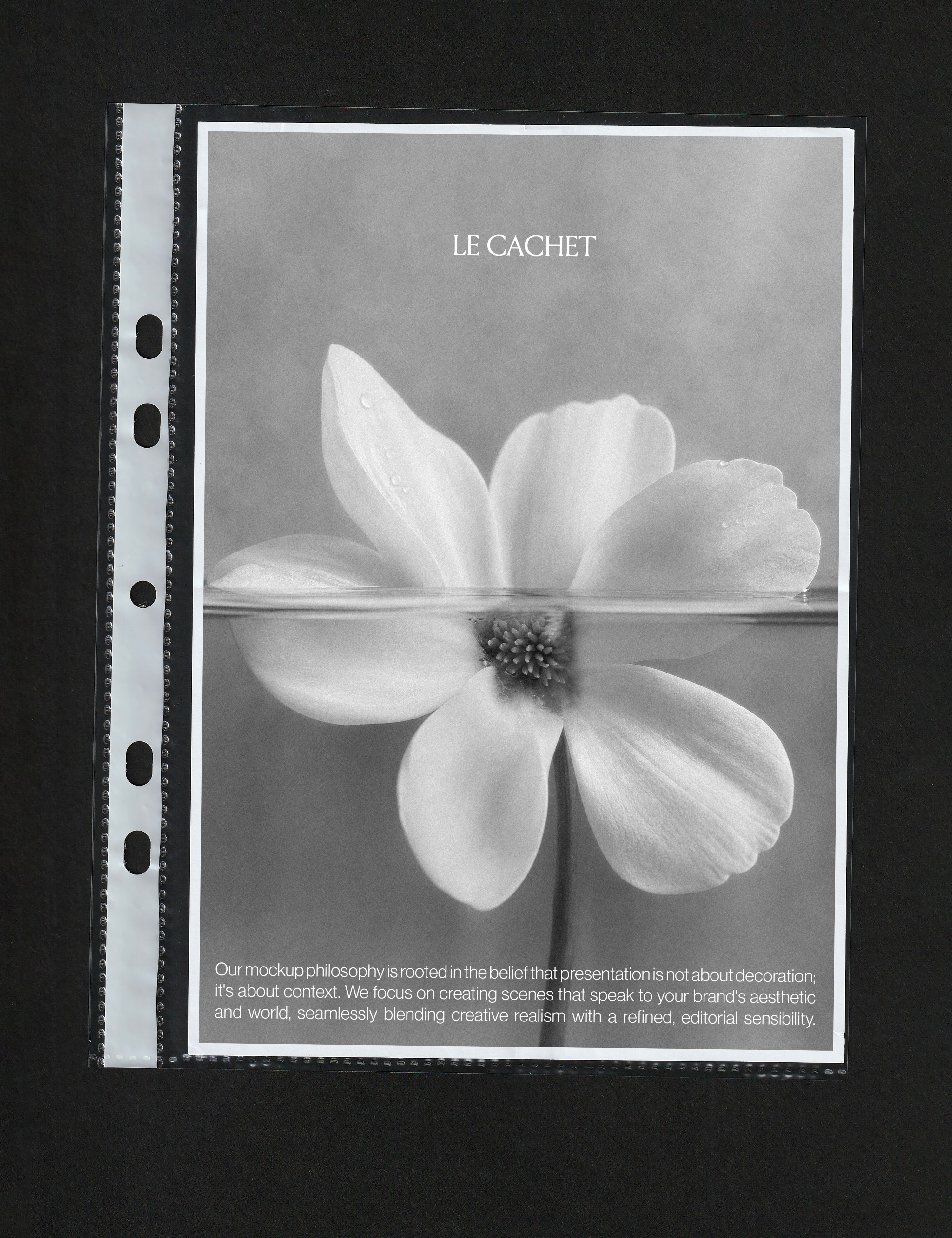 Paper mockup in a clear punched pocket, grey flower poster print with white border on black background