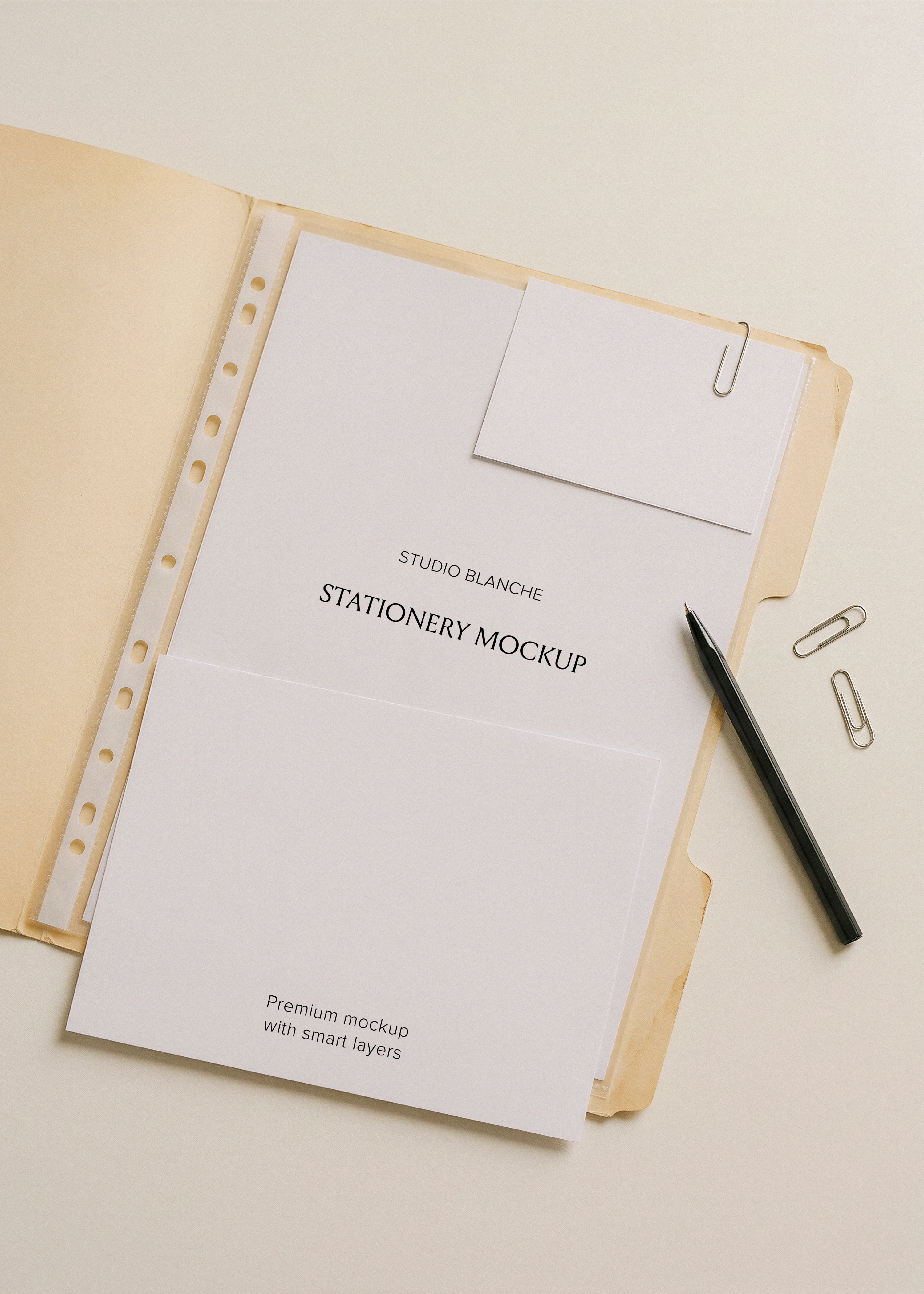 Blank A4, A5 and small business card in archival manila folder with black pen and silver paper clips, flat lay scene