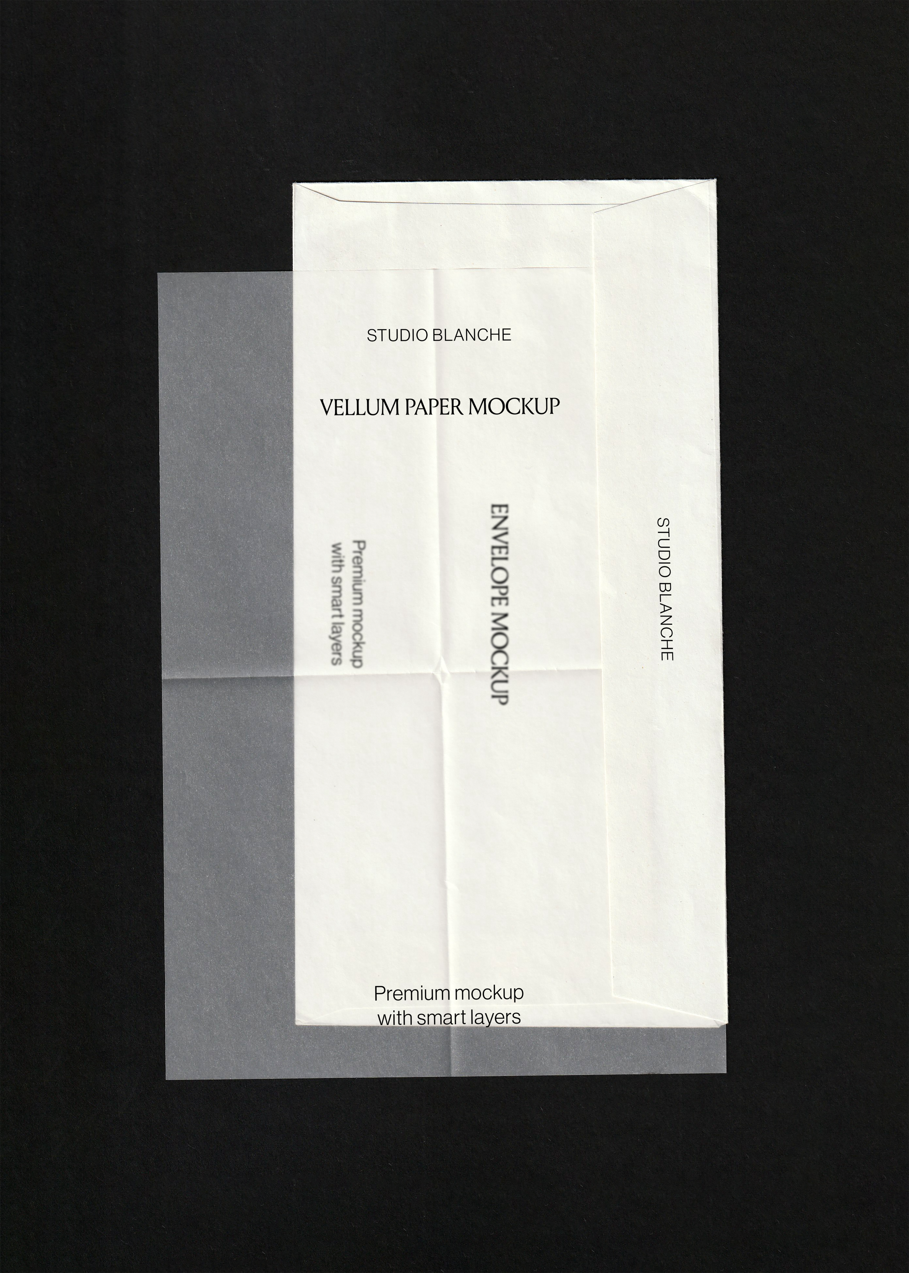 Scanned stationery mockup, creased white envelope layered under a grey translucent vellum sheet on black