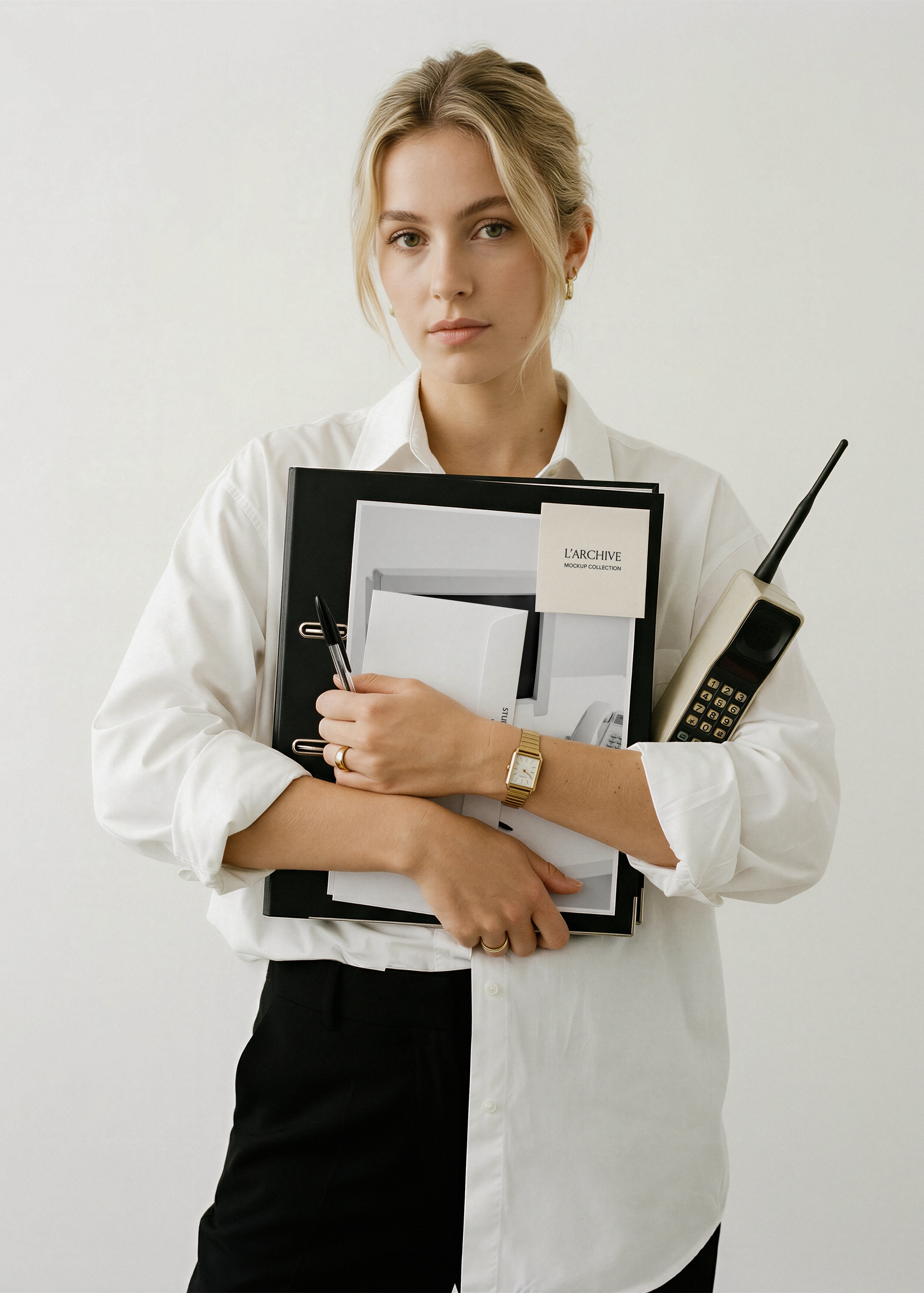 A4 card, envelope and sticky note stationery mockup held against black binder with white shirt, gold watch and vintage phone