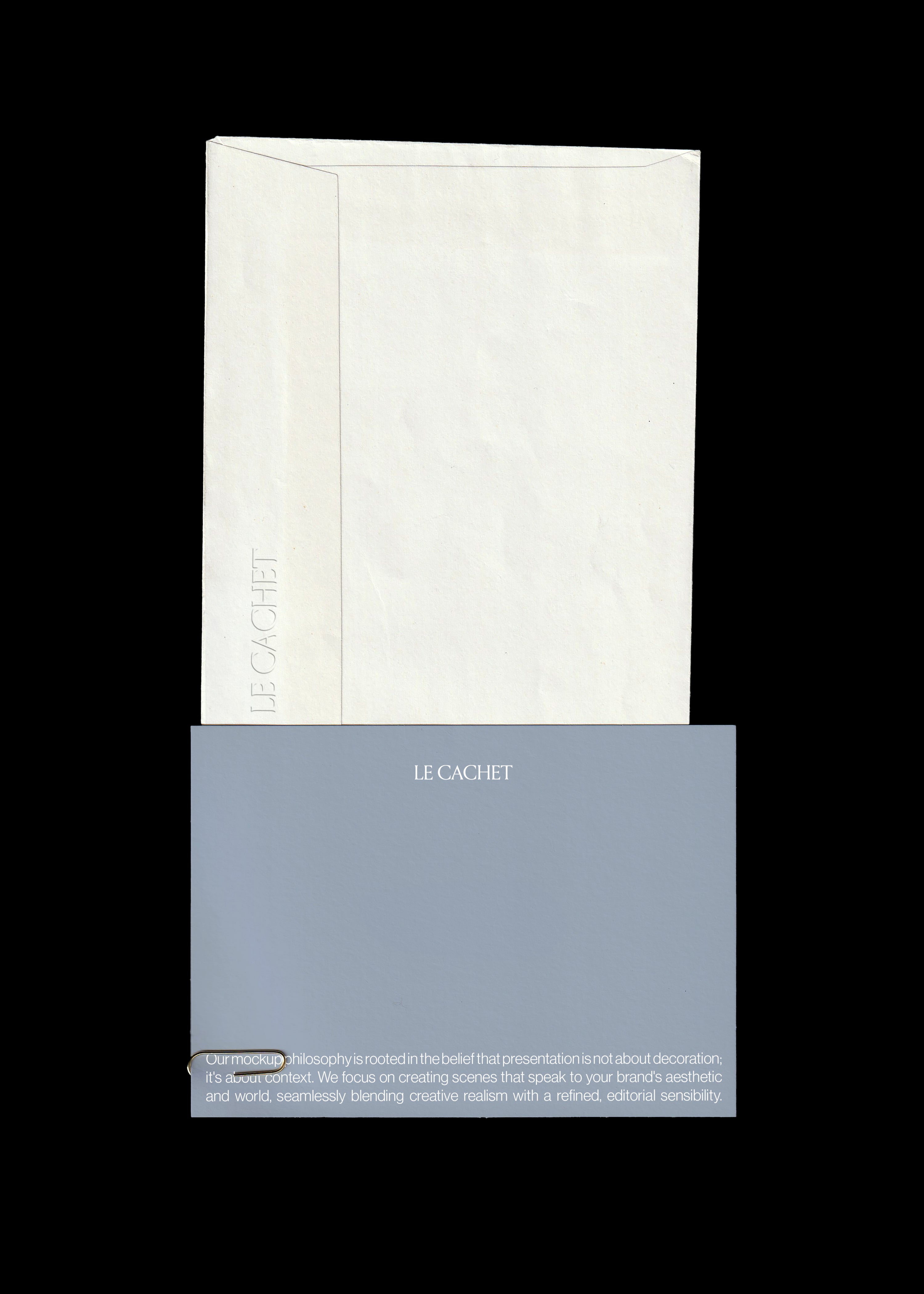 Scanned card and envelope mockup with a dusty blue card and cream textured envelope on a black background
