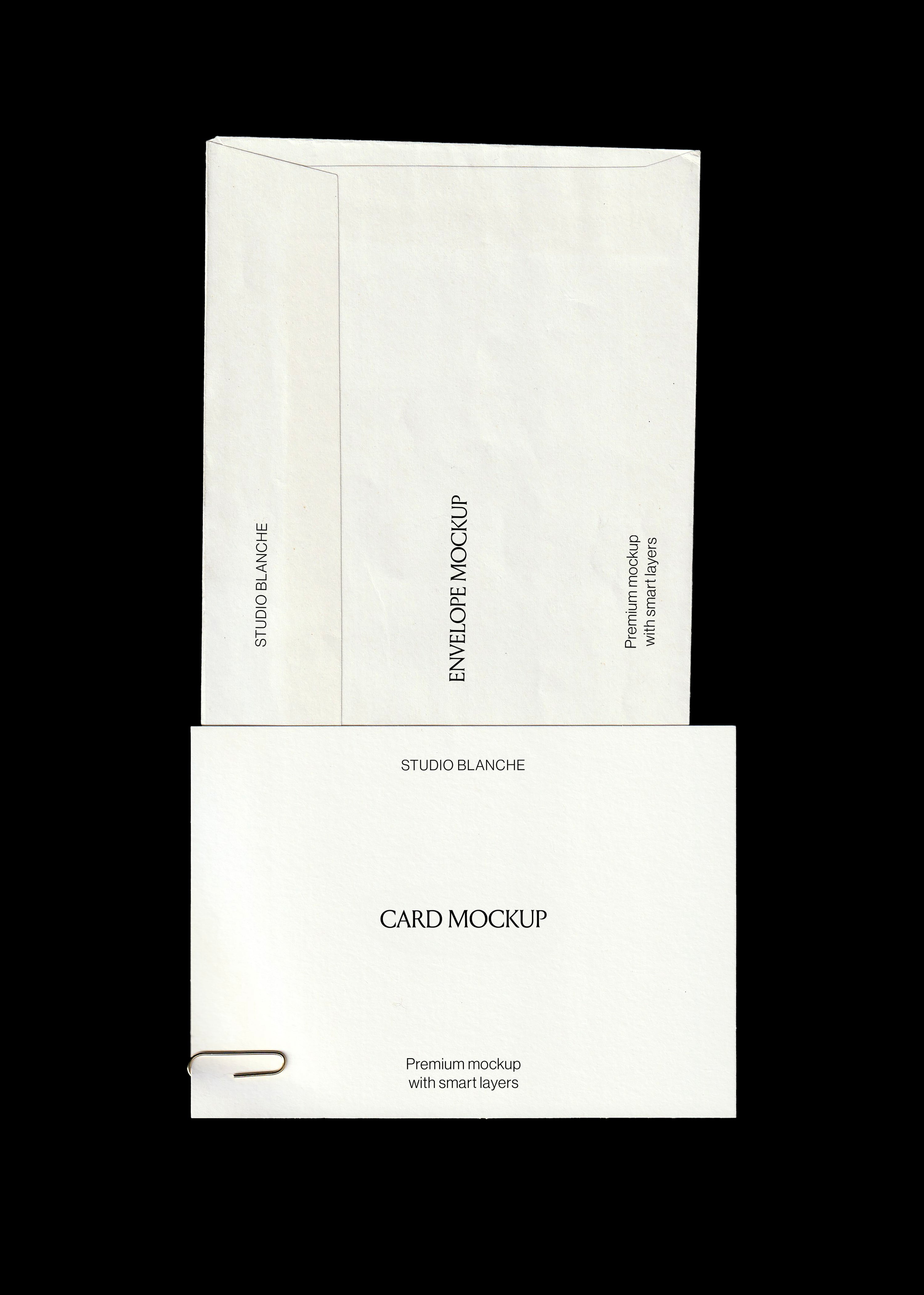 Envelope and card mockup in cream paper with a small gold paperclip clipped to the card edge, black backdrop