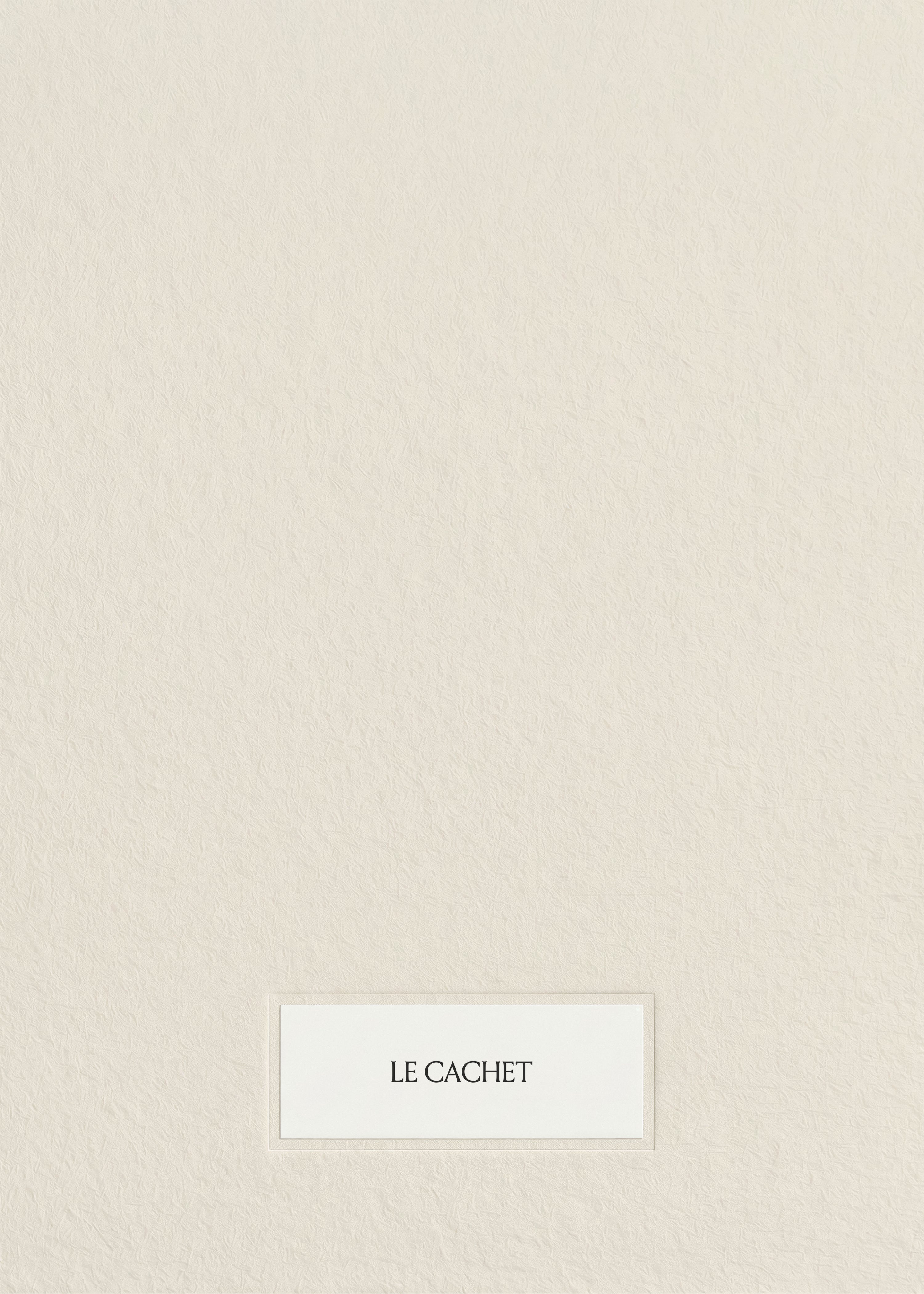 Stationery mockup with a small white card centred low on warm textured cream paper, minimal tonal styling