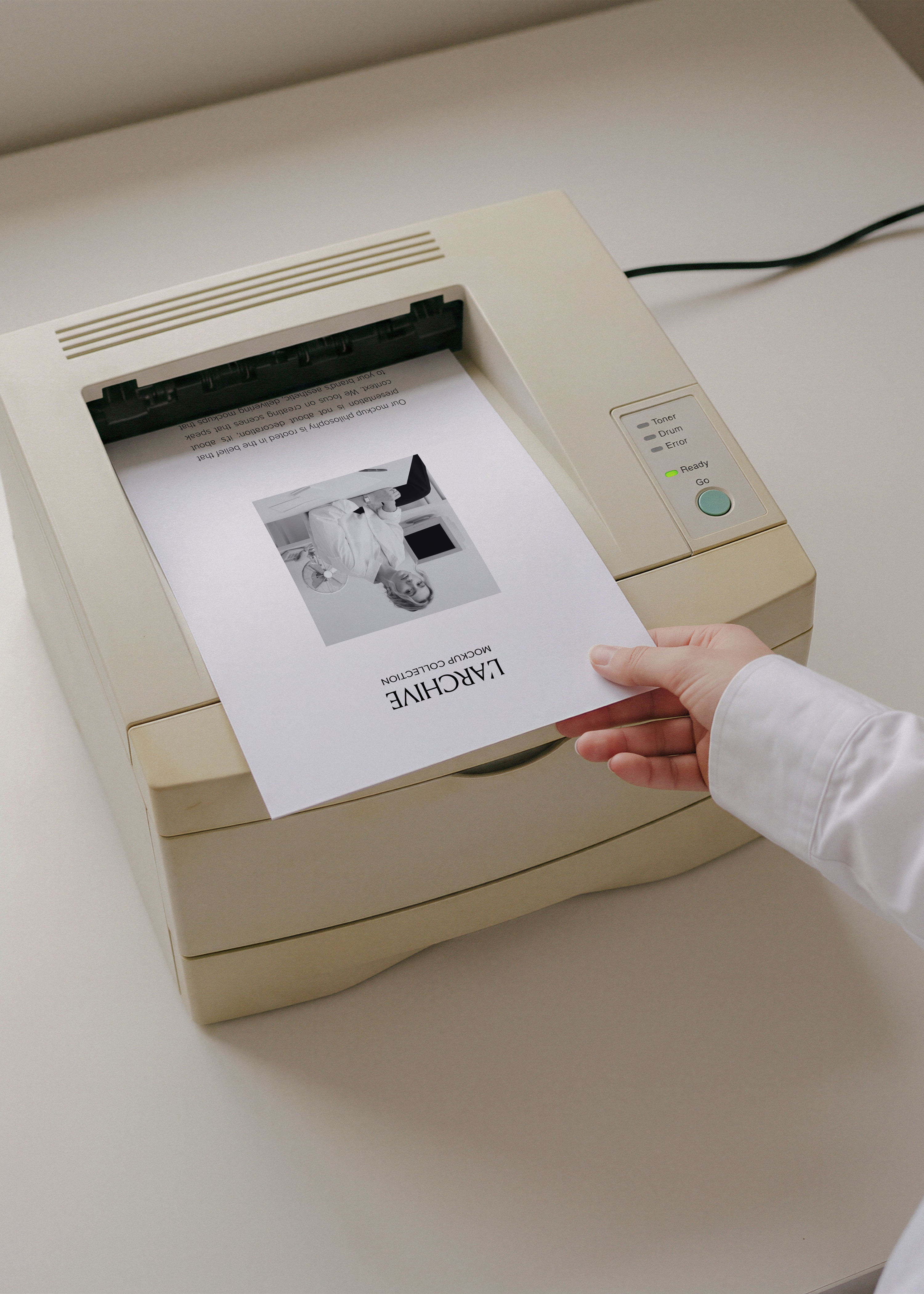 A4 paper stationery mockup printing from cream vintage laser printer, hand in white shirt lifting sheet from output tray