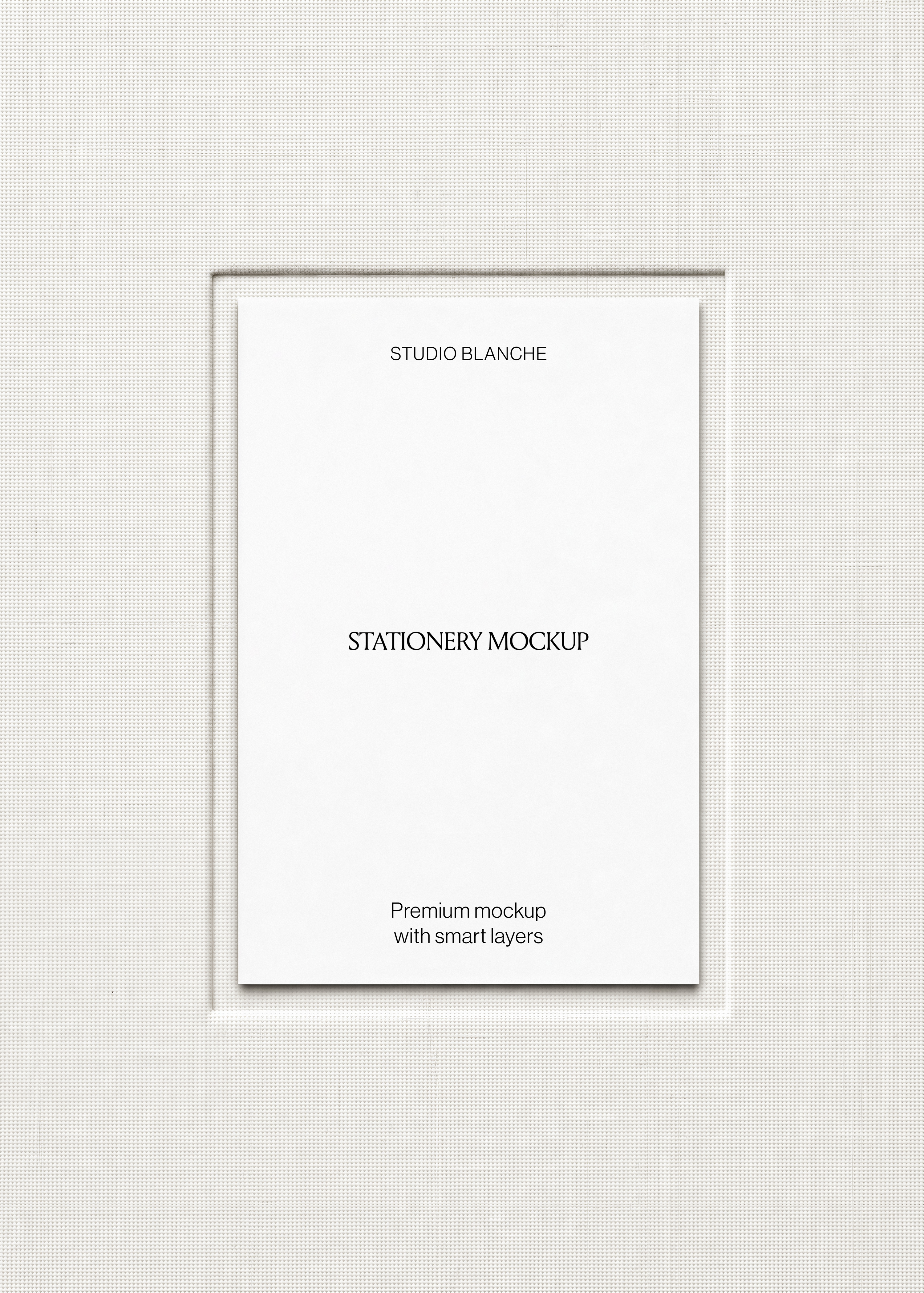 Close view of white poster card on woven cream mount board, blank layout with thin bevelled window, neutral tones