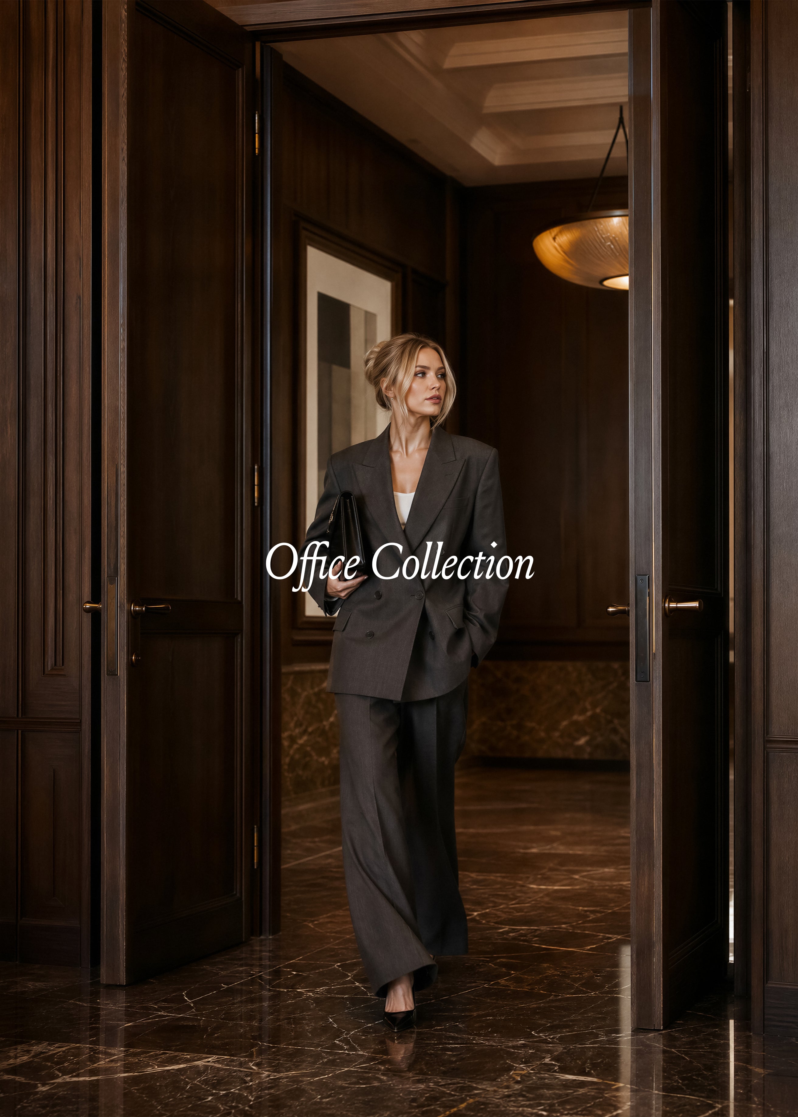 Woman in charcoal suit walking through dark wood-panelled corridor, warm gold ceiling lights, Office Collection editorial stock