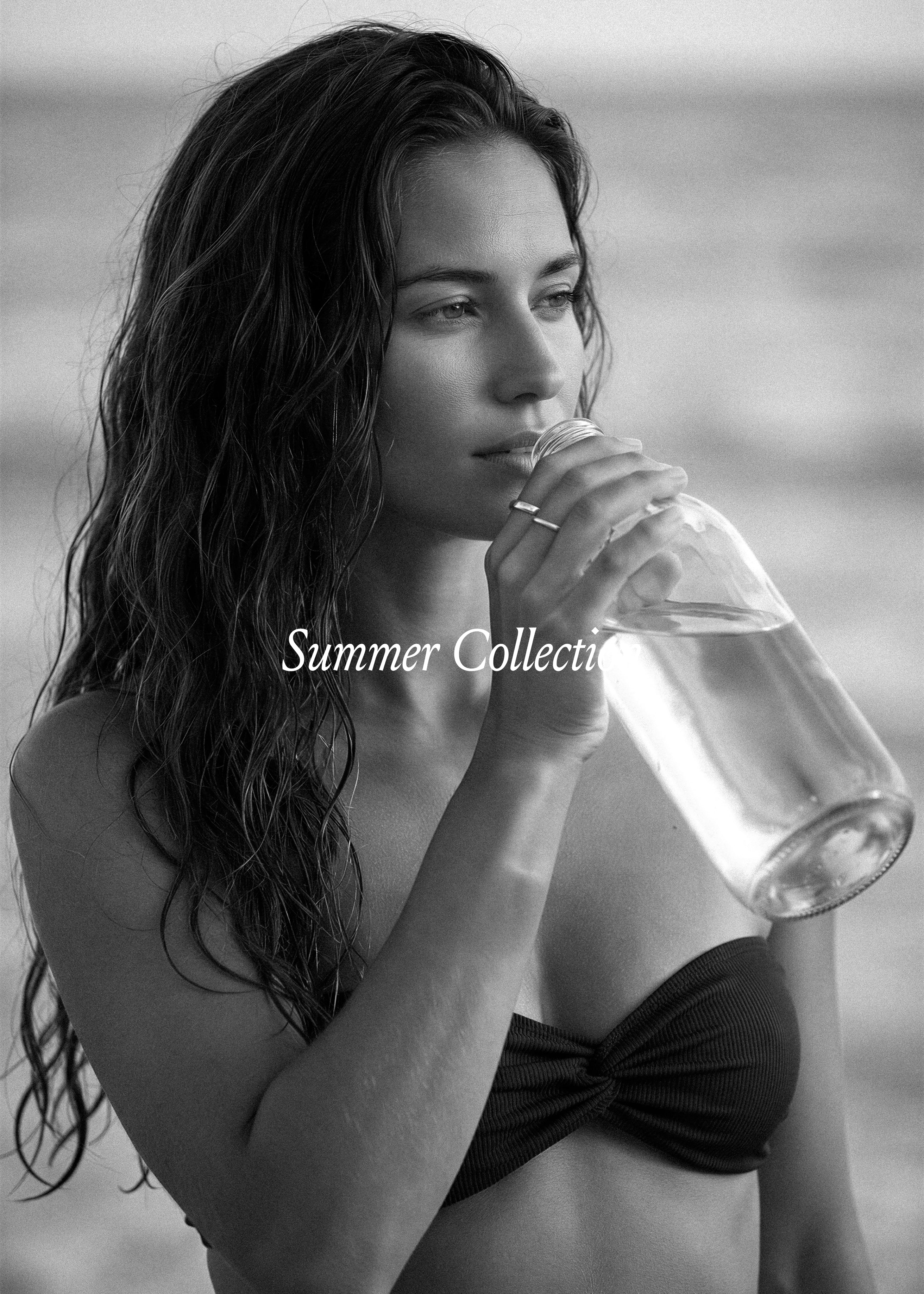 Summer stock collection cover in black and white, woman with wet hair drinking from a glass bottle, coastal editorial