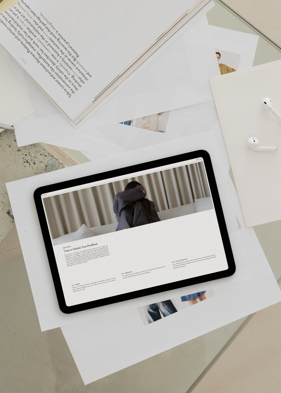 Tablet displaying a website on top of scattered papers