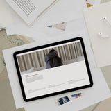 Tablet displaying a website on top of scattered papers