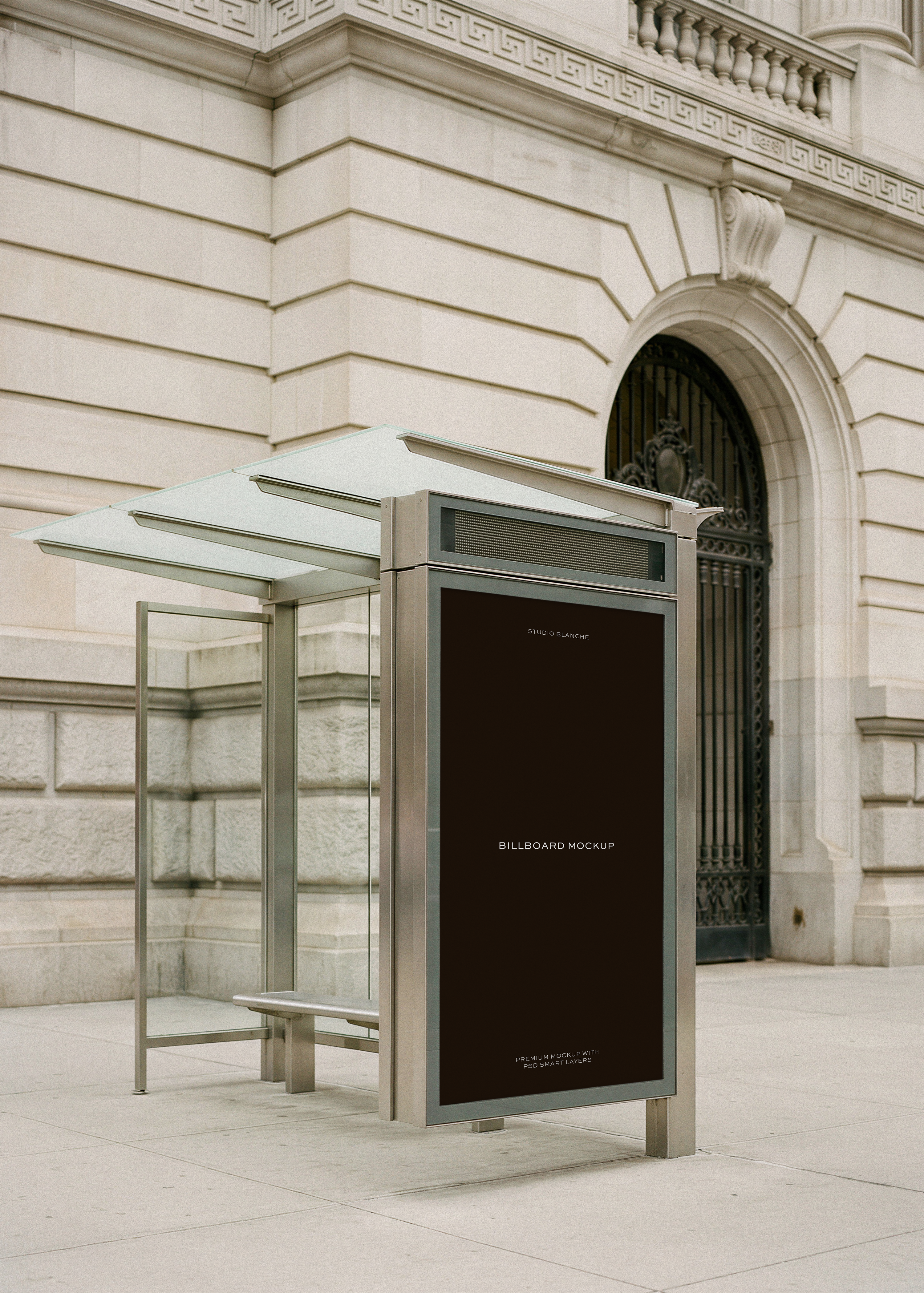 Bus shelter billboard mockup at street level against classical New York architecture, from Studio Blanche
