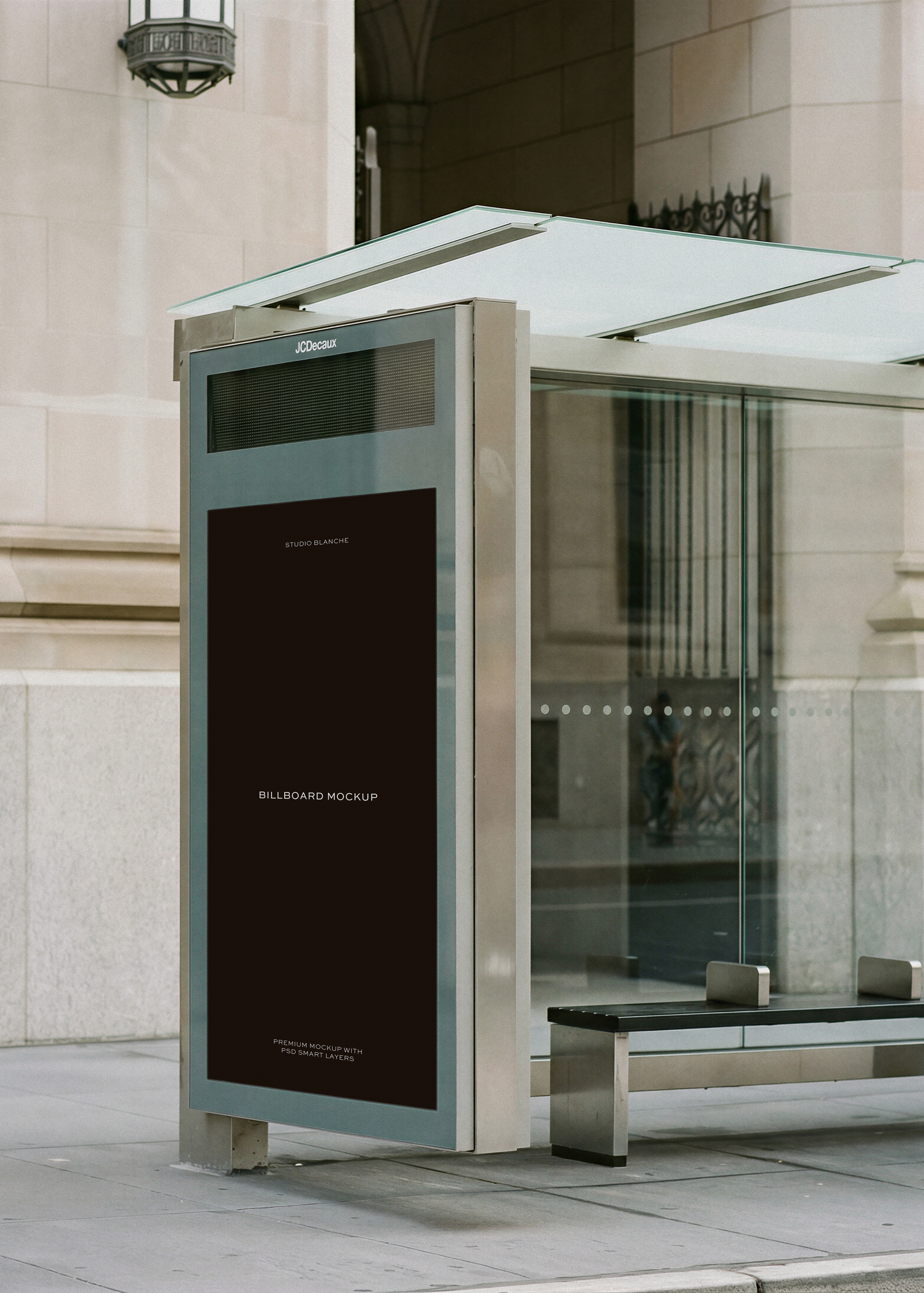 Bus shelter billboard mockup on New York pavement with stone architecture and lantern, from Studio Blanche
