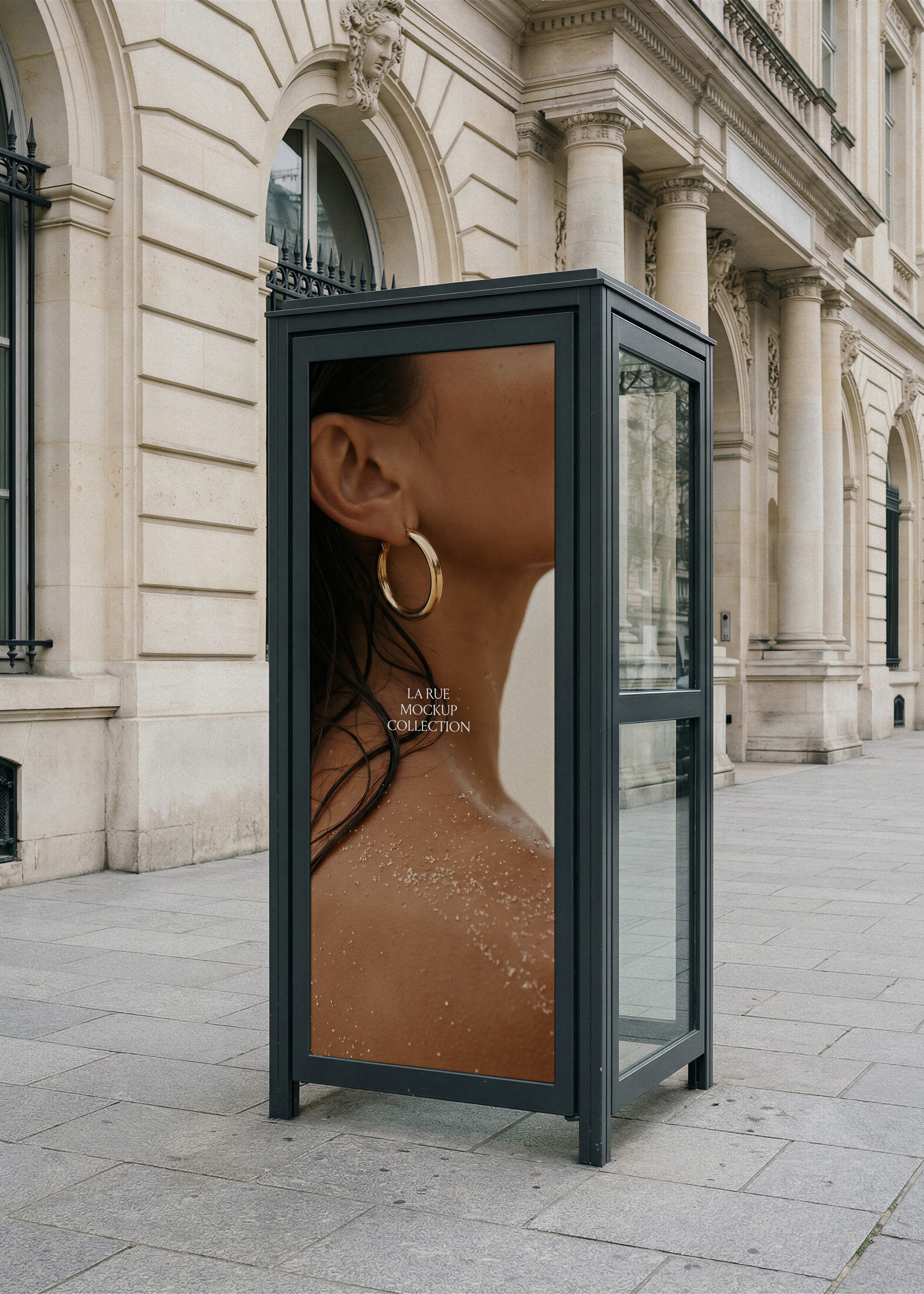 Telephone booth mockup with black steel frame on a Parisian pavement, displaying beauty and jewellery campaign by Studio Blanche