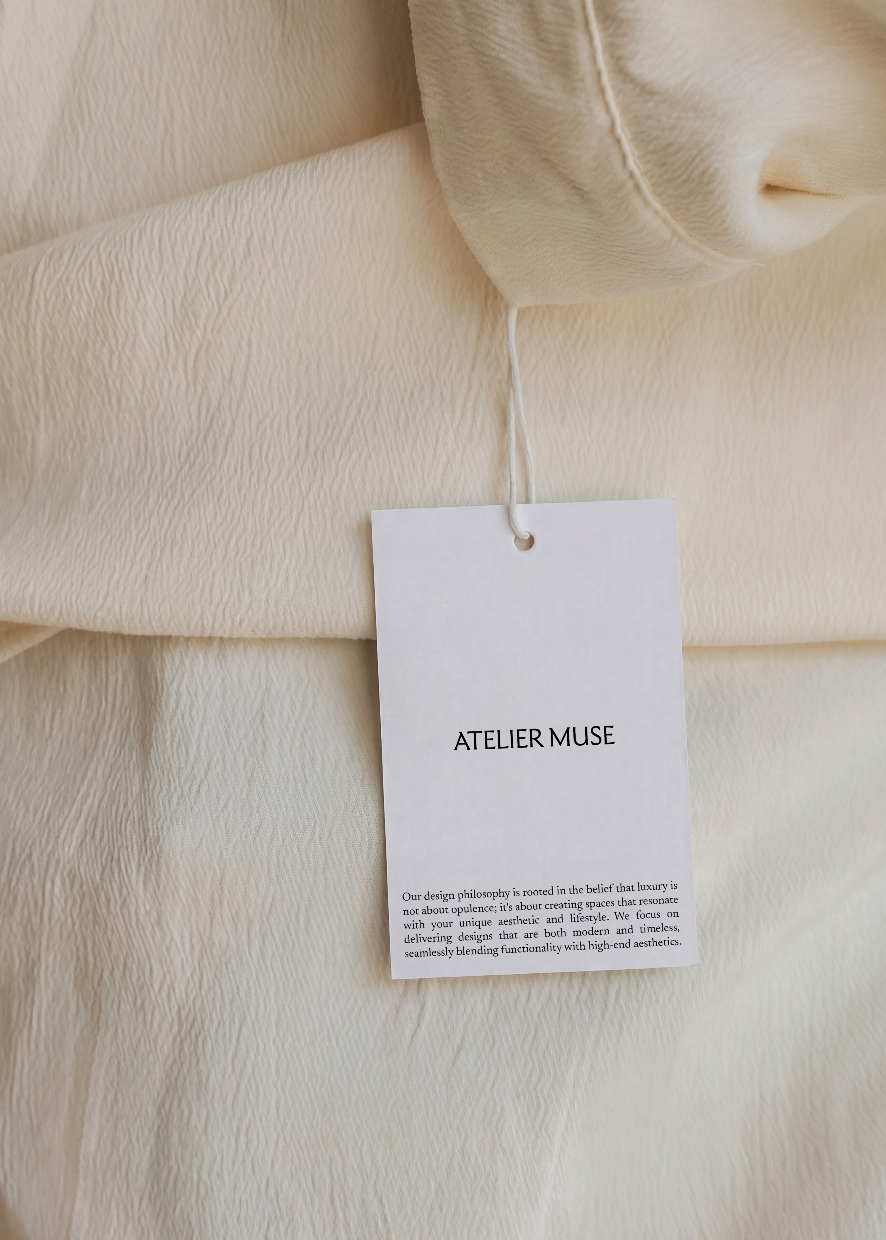 Free swing tag mockup on cream fabric with minimalist branding, from Studio Blanche