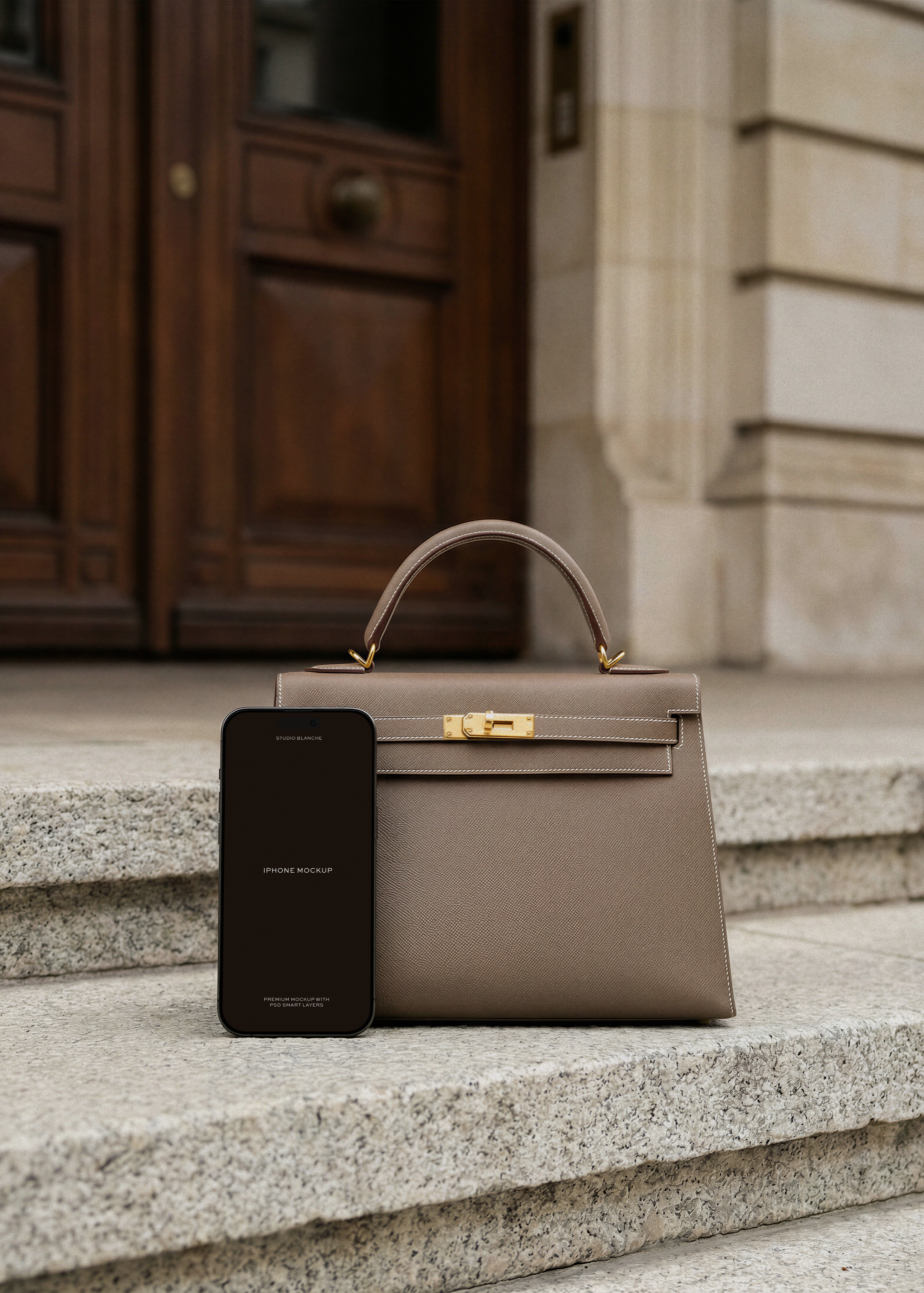 iPhone mockup on stone steps with taupe leather Hermès Kelly handbag, from Studio Blanche