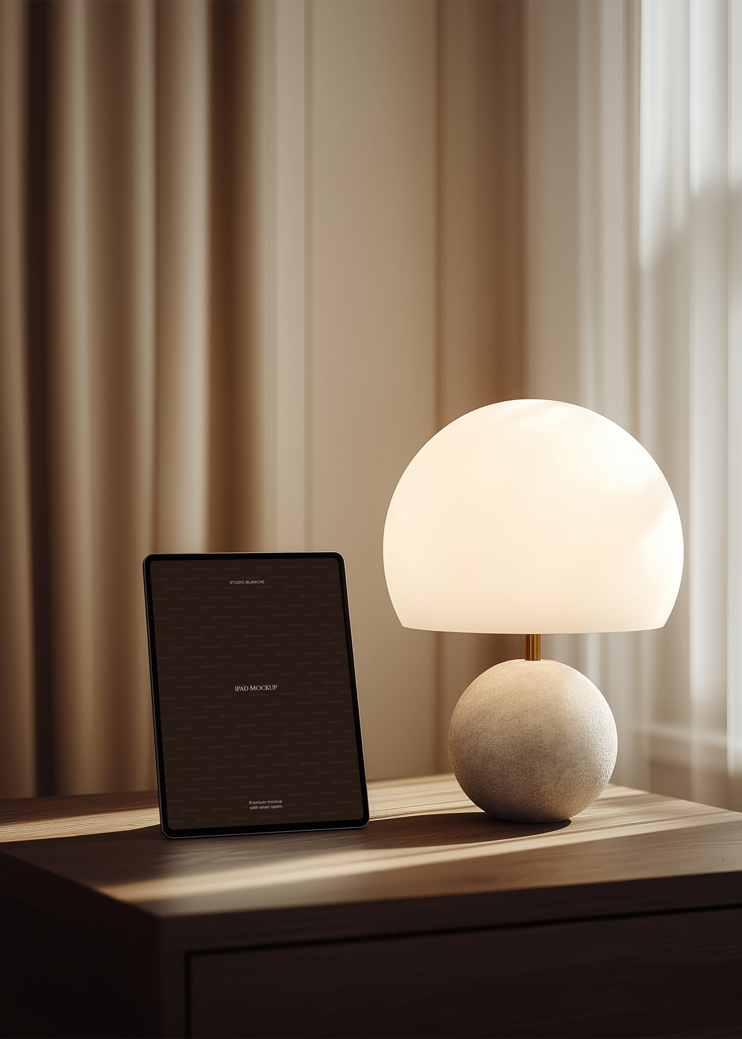 iPad mockup upright on oak sideboard beside frosted globe lamp on stone sphere base, warm minimal interior scene