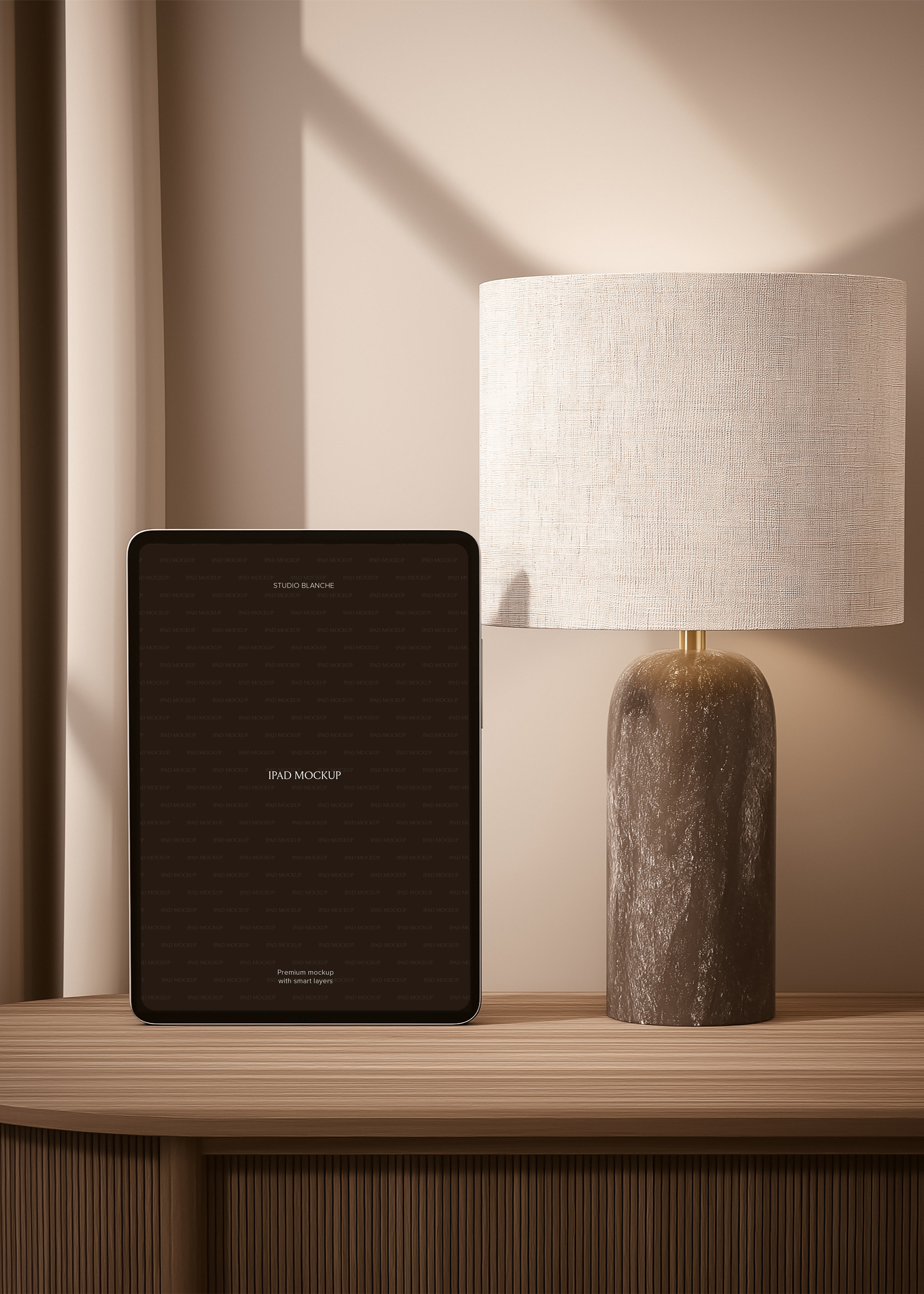 iPad mockup in portrait orientation on ribbed oak console beside dark stone lamp with linen shade, warm tonal interior