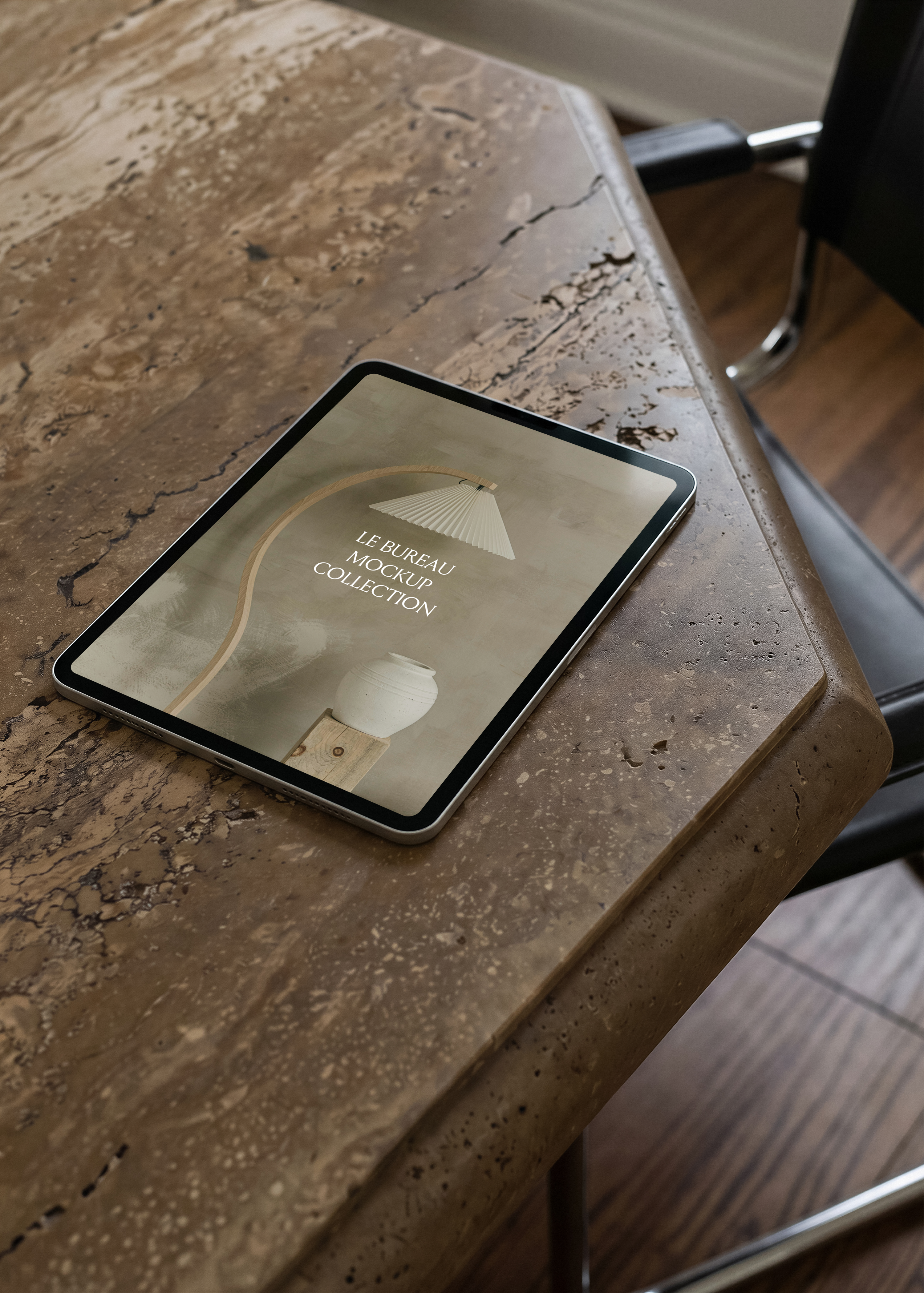iPad mockup on travertine surface displaying Le Bureau editorial image, moody warm architectural scene