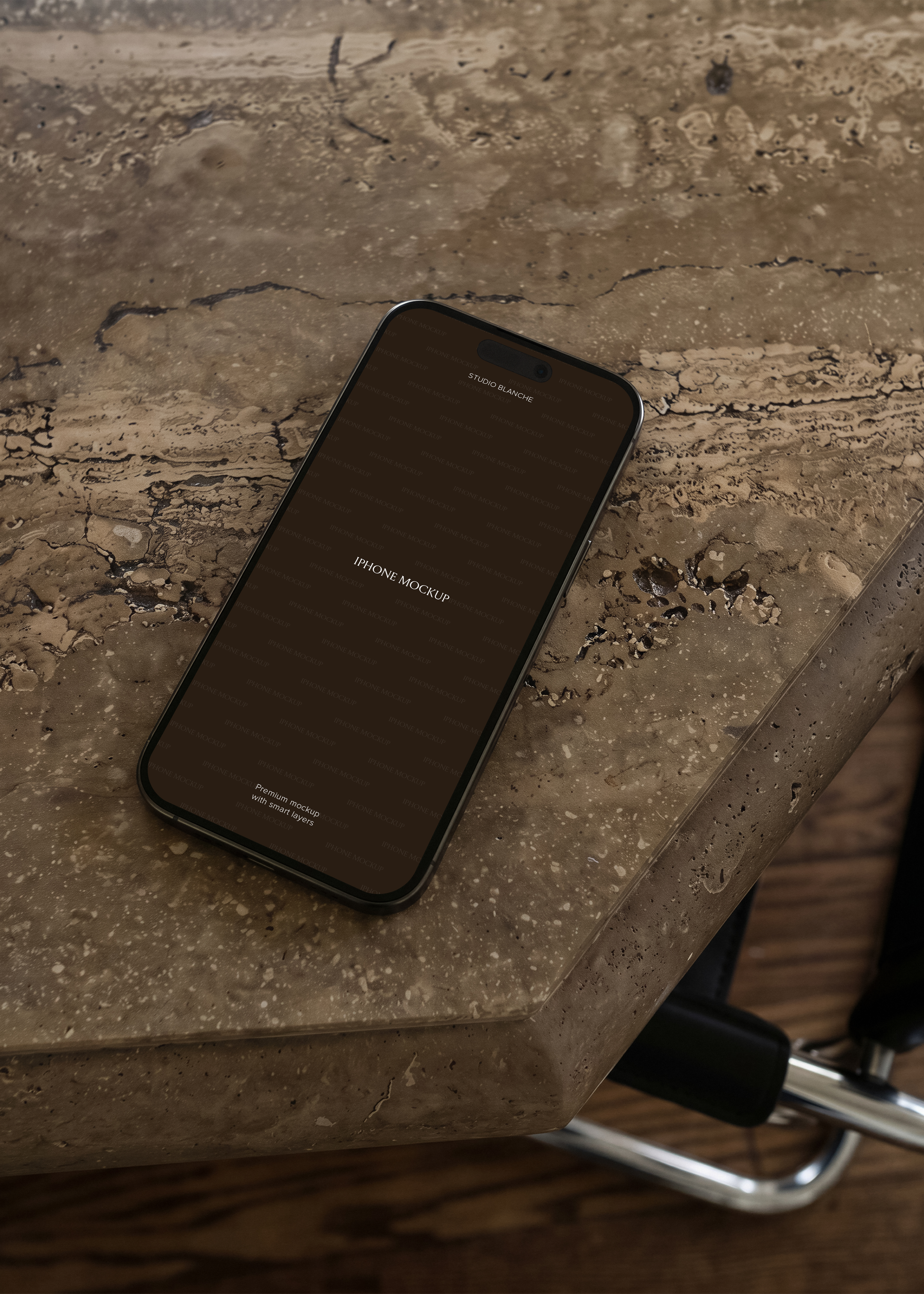 iPhone mockup resting at an angle on textured travertine surface beside chrome chair leg, warm tones