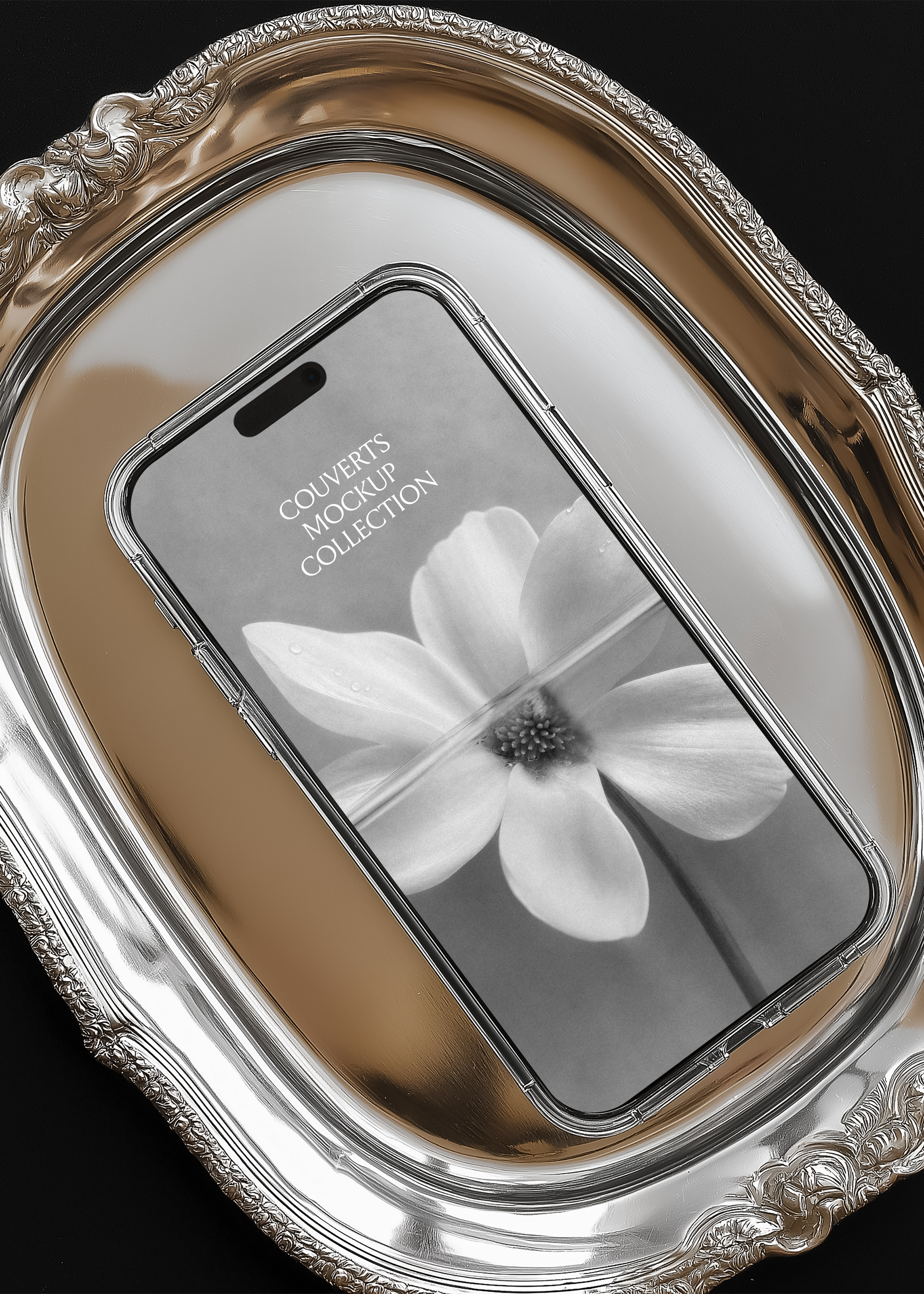 iPhone mockup inside ornate silver serving tray, angled overhead view, black background, editorial luxury scene