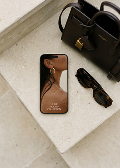 iPhone mockup with luxury jewellery brand screen, styled with Saint Laurent handbag and Celine sunglasses on travertine stone steps, from Studio Blanche