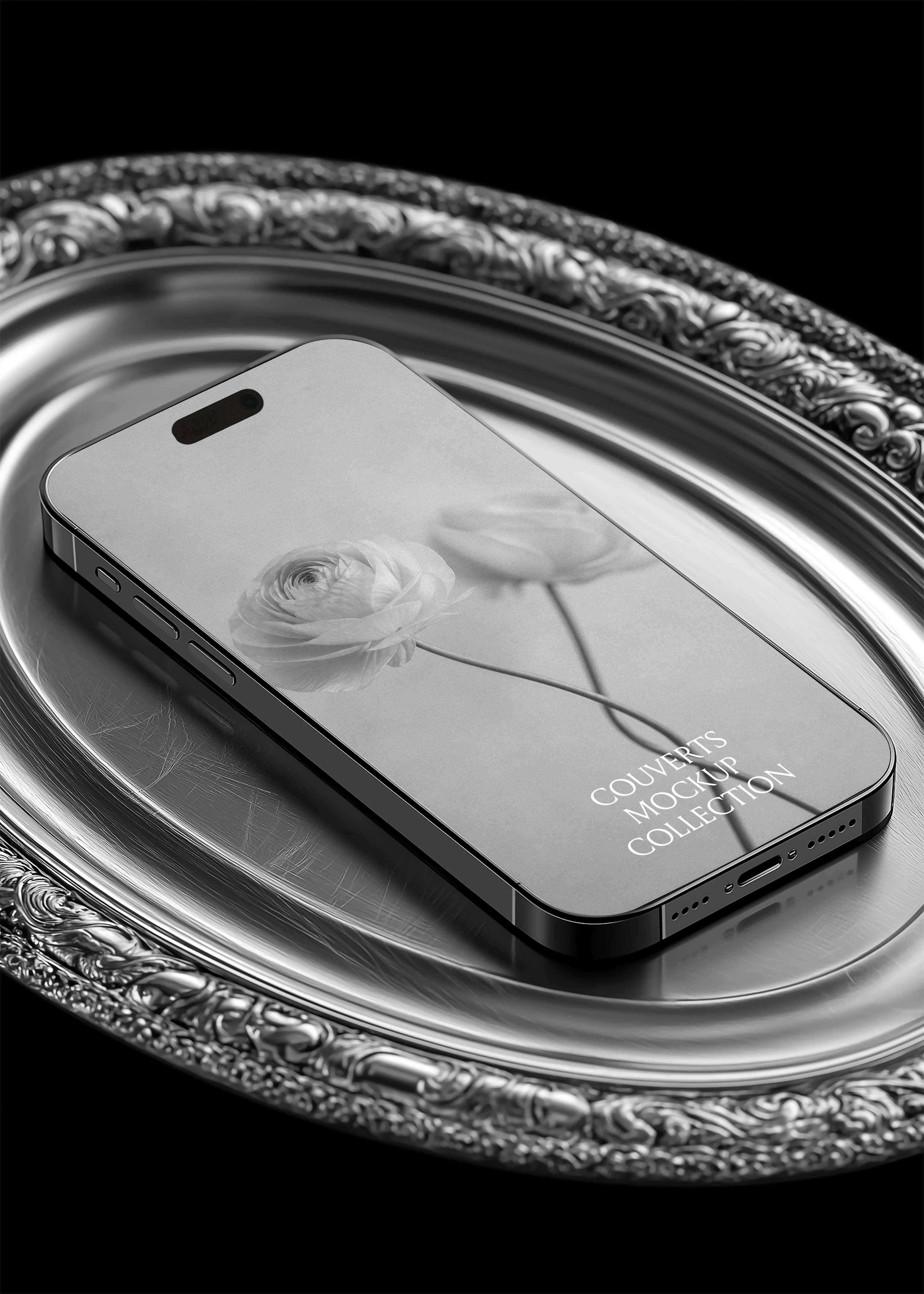 iPhone mockup lying flat on ornate antique silver oval tray, low three-quarter angle view, black background, editorial luxury styling
