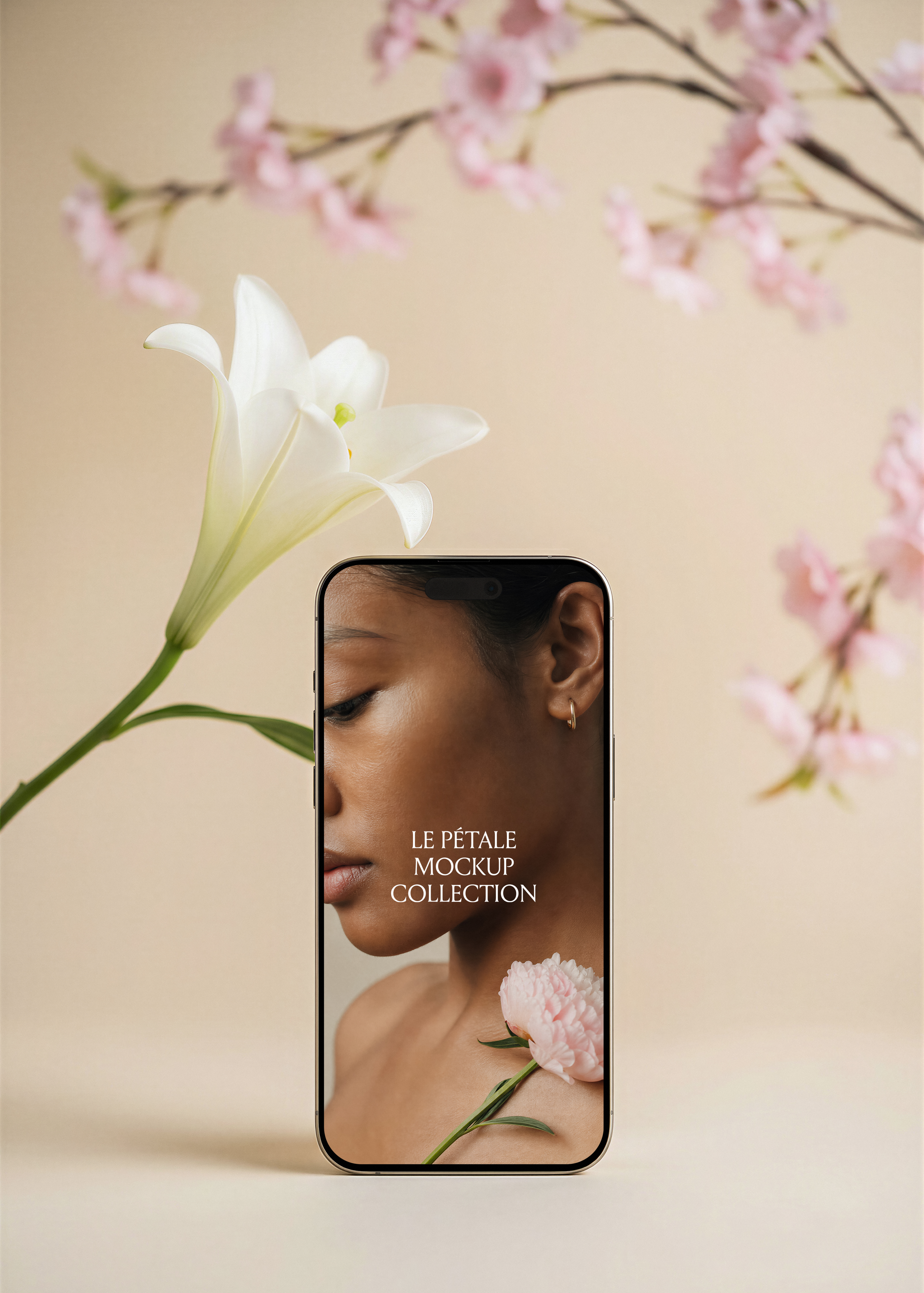 Gold frame iPhone mockup with beauty campaign screen, white lily left, pink cherry blossom branches background, warm sand backdrop