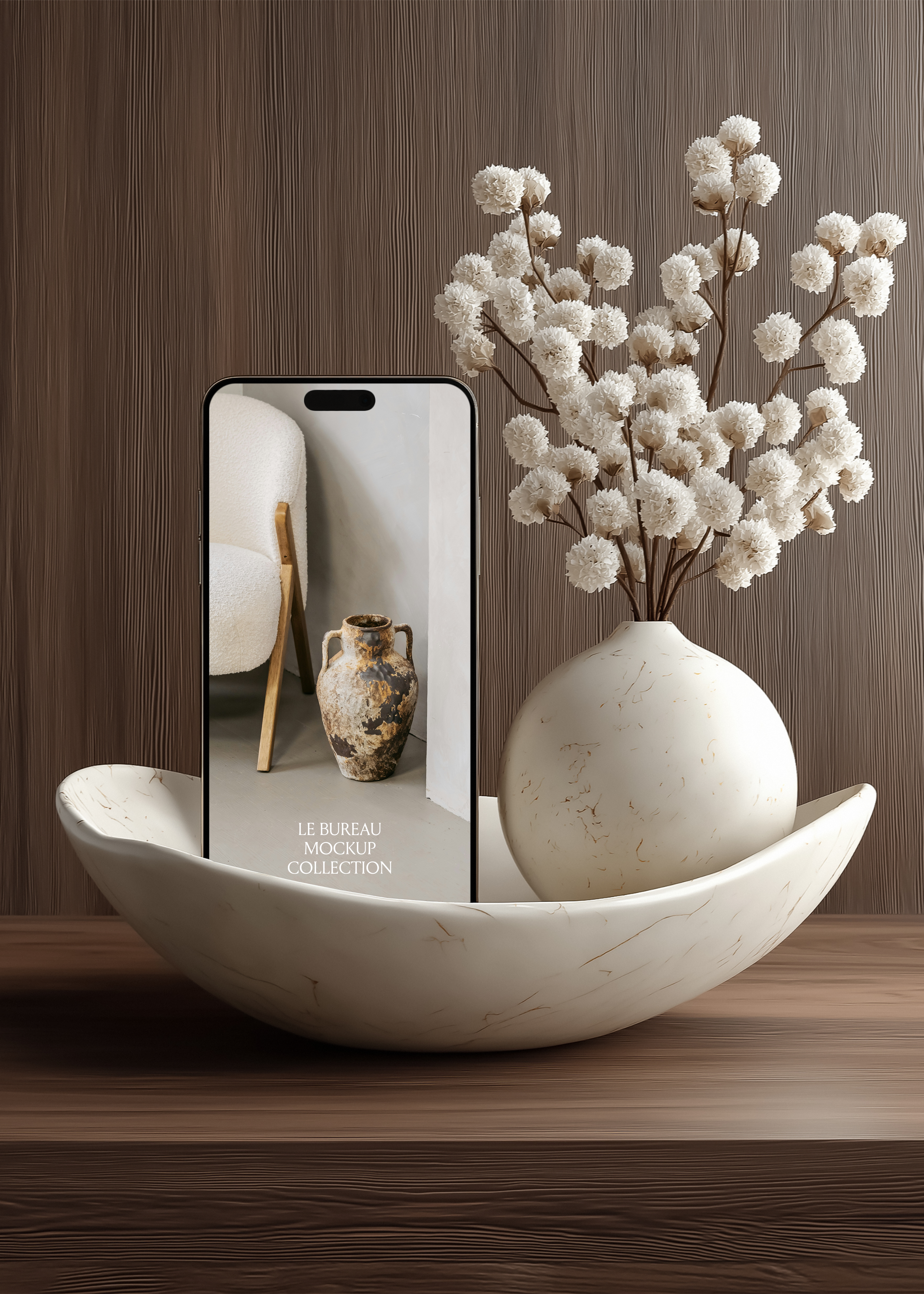 iPhone mockup displaying Le Bureau editorial in marble bowl, globe vase with white dried florals and dark wood-grain background