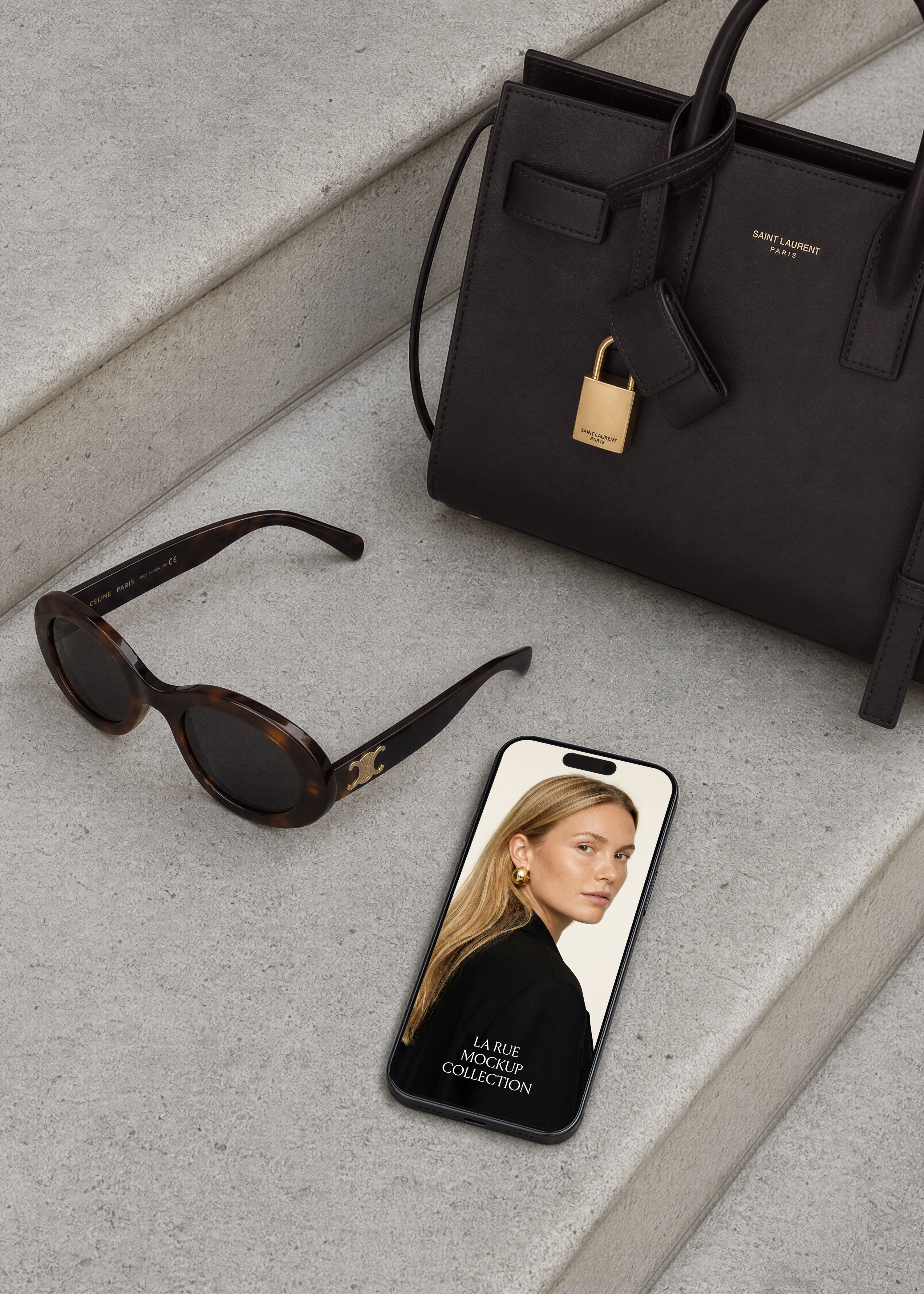 iPhone on stone steps beside tortoiseshell sunglasses and black structured leather bag, screen showing editorial fashion website