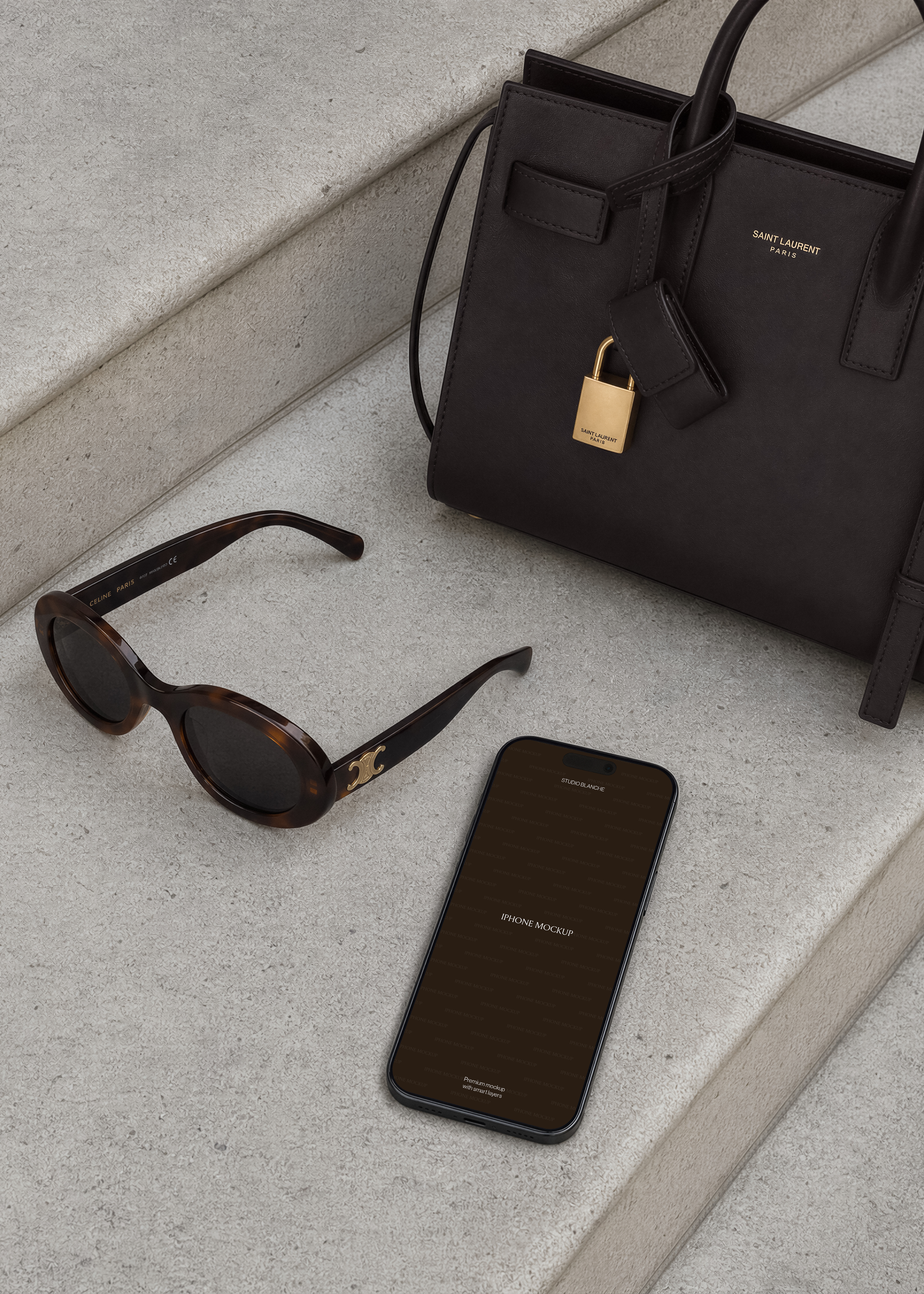 iPhone mockup flatlay on stone steps with luxury accessories, dark placeholder screen, minimal editorial styling