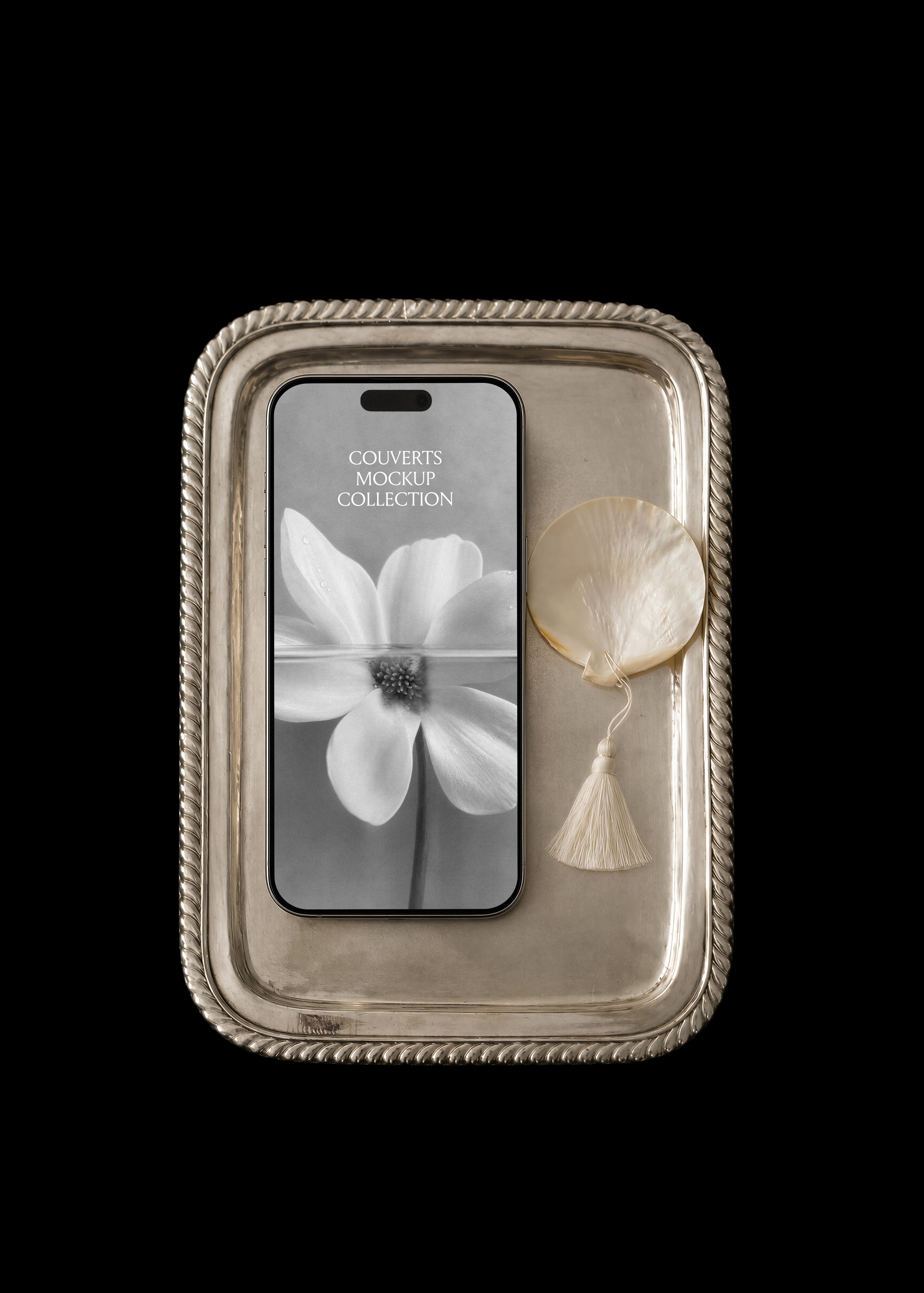 iPhone mockup with black and white floral screen on an antique silver tray with mother-of-pearl shell and tassel